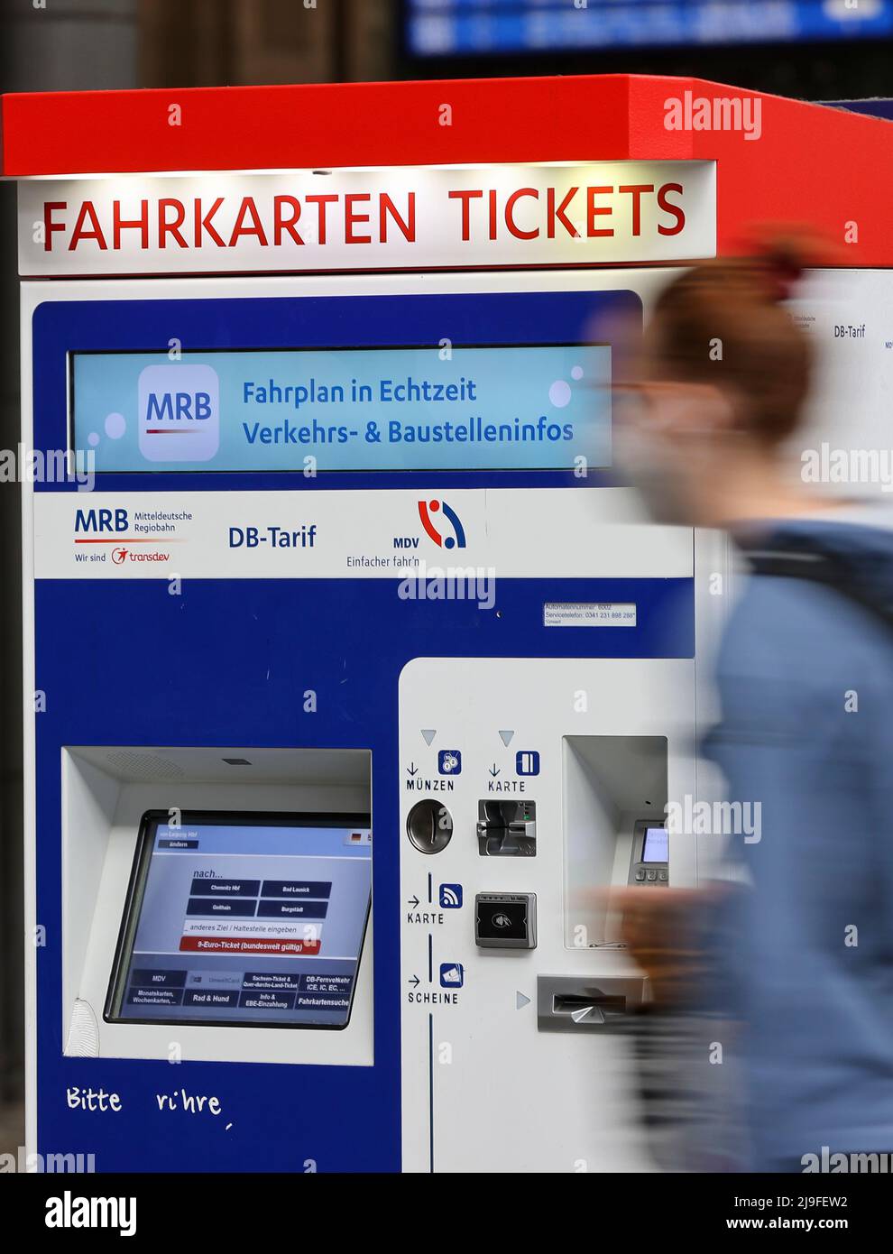 Leipzig, Germany. 23rd May, 2022. A woman walks past a ticket vending machine of the Mitteldeutsche Regiobahn (MRB) at Leipzig Central Station. People in Saxony will be able to buy the 9-euro ticket for public transportation starting this Monday. The ticket is usually available from vending machines, sales outlets or bus drivers and will be valid nationwide from June 1. Credit: Jan Woitas/dpa/Alamy Live News Stock Photo