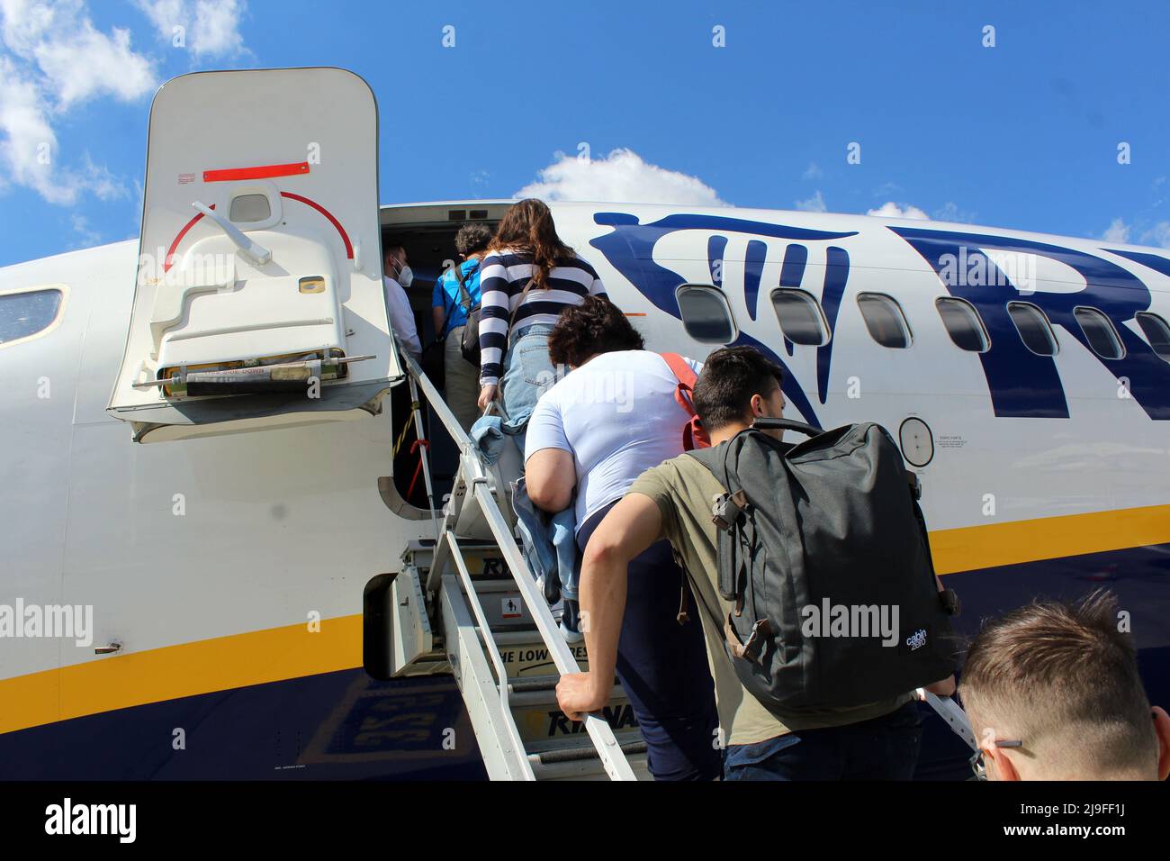 Passengers (tourists) are boarding airplane of Ryanair (the Irish Low