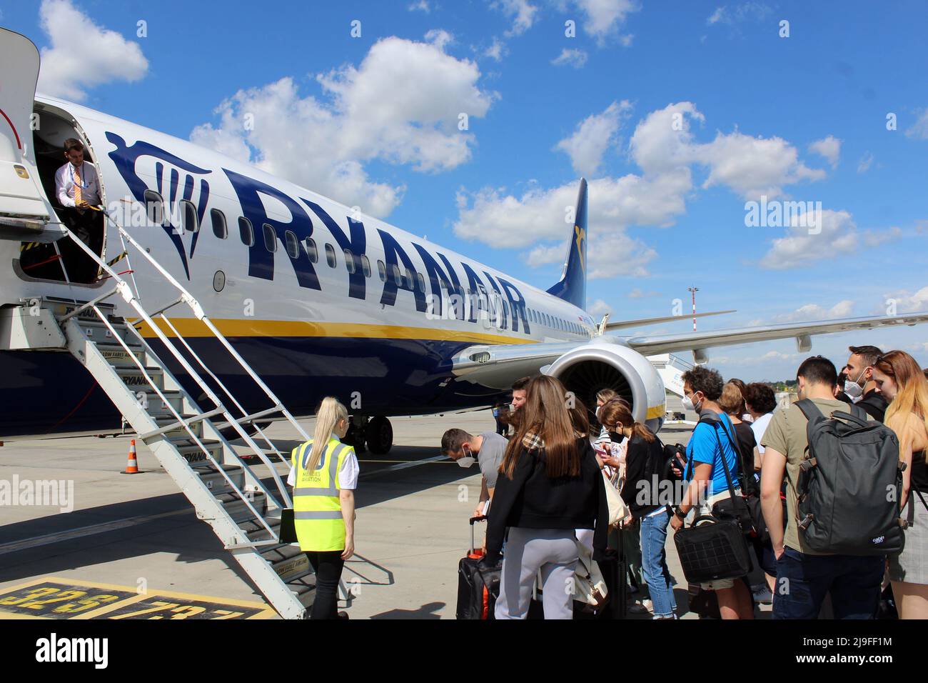 Passengers (tourists) are boarding airplane of Ryanair (the Irish Low