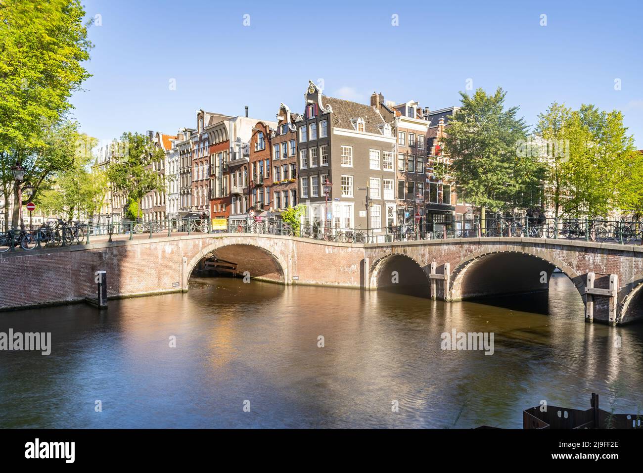 Amsterdam, Netherlands bridges and canals during a sunny day.  Stock Photo