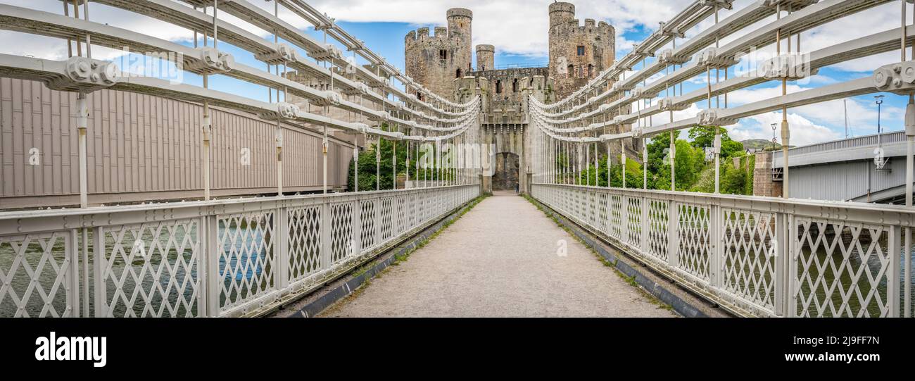 The Conwy Suspension Bridge is a Grade I-listed structure and is one of the first road suspension bridges in the world and Conwy Castle. Stock Photo