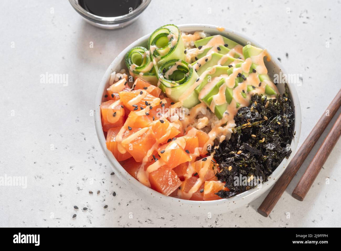 Hawaiian Salmon Poke Bowl with avocado, cucumber, rice and sesame seeds ...