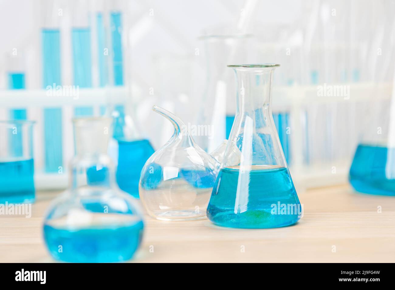 Laboratory glassware with blue liquid in a test tube. scientific ...