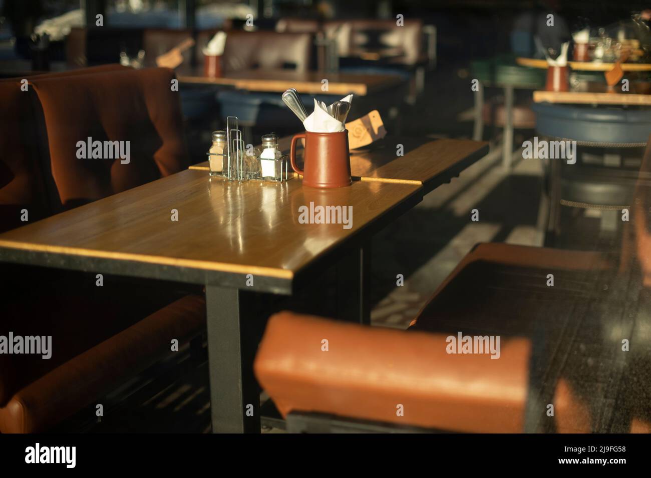 Table in restaurant. Place to eat. Leather sofa and table. Stock Photo