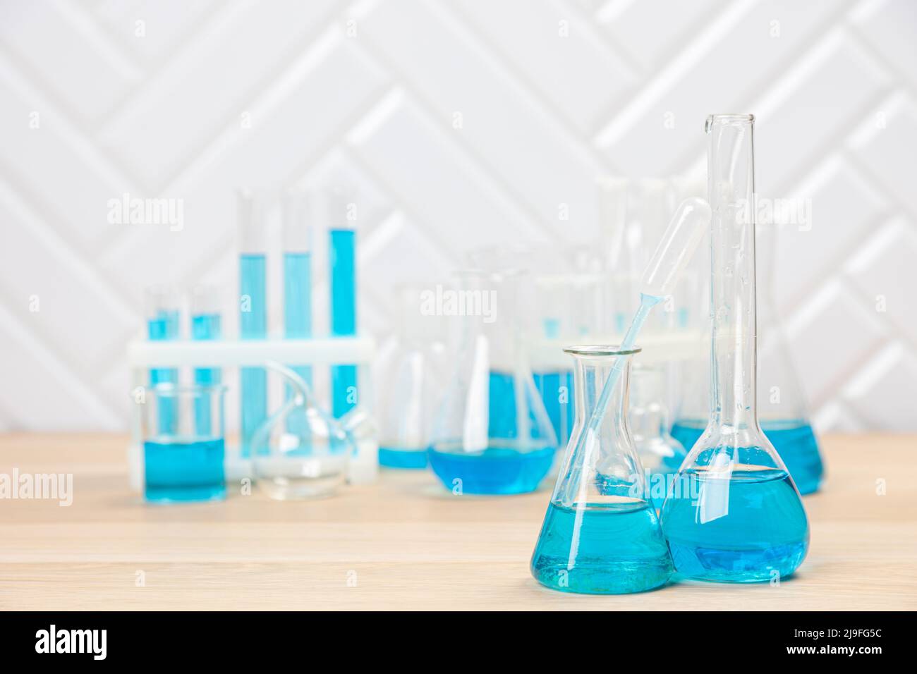 Laboratory glassware with blue liquid in a test tube. scientific ...