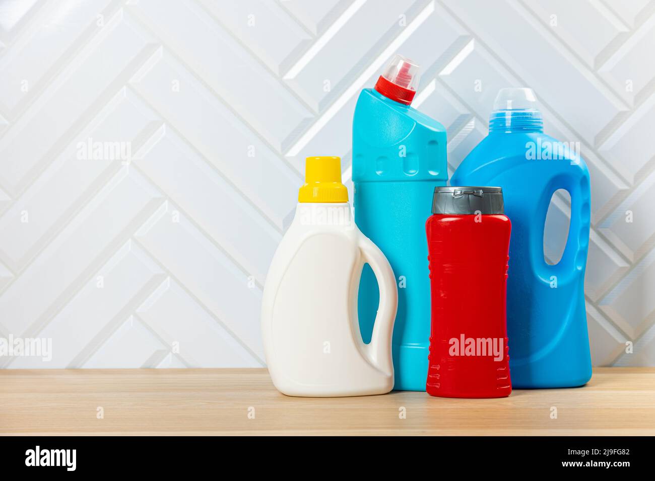 Cleaning bottles for different surfaces in kitchen, bathroom and other rooms. Spring regular cleanup. Set home cleaning products Stock Photo