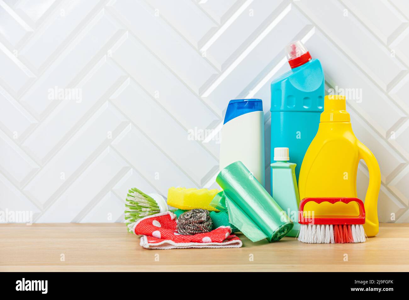 Cleaning concept. Set of cleaning detergents in colored plastic bottles