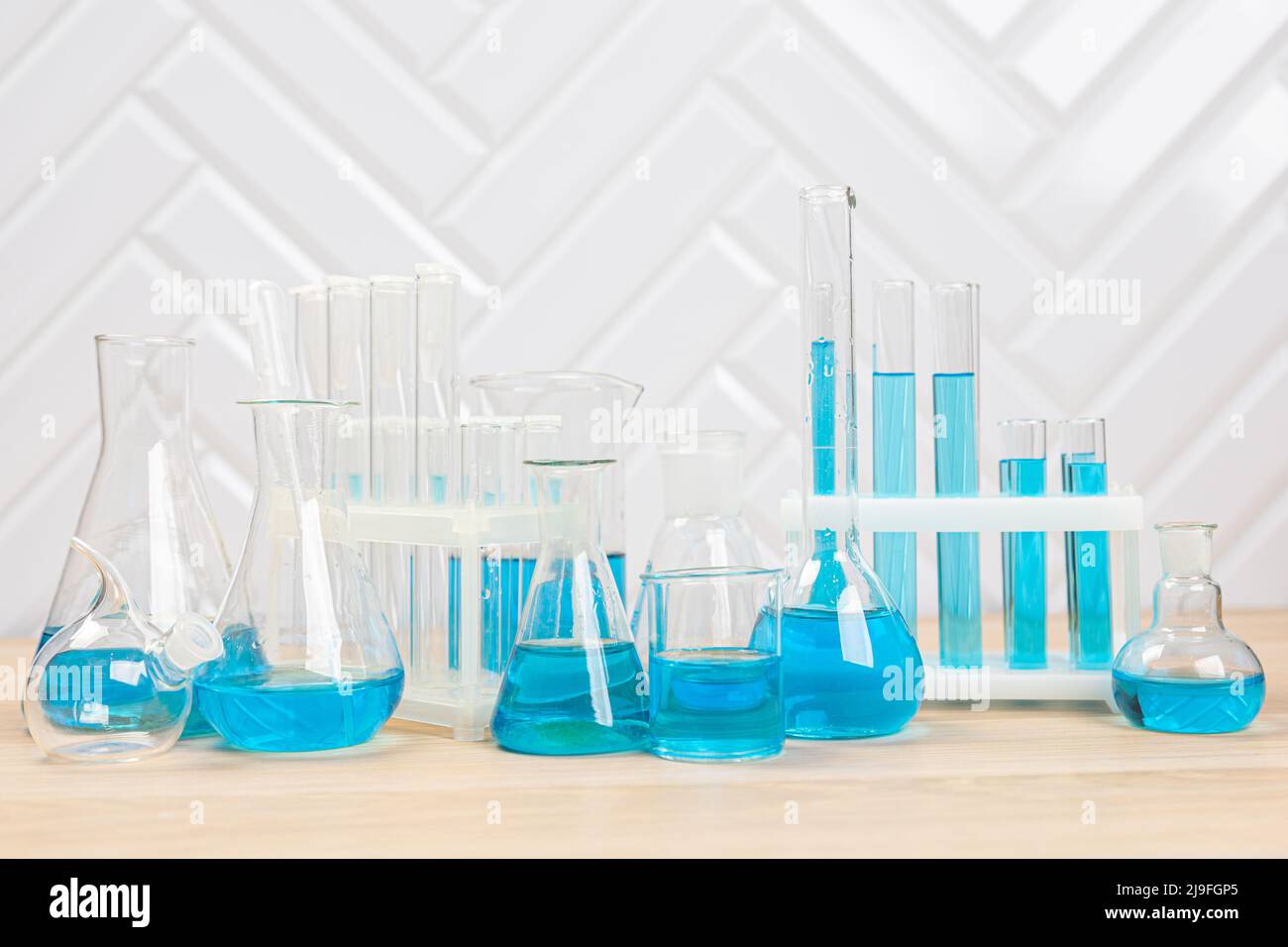 Laboratory glassware with blue liquid in a test tube. scientific ...