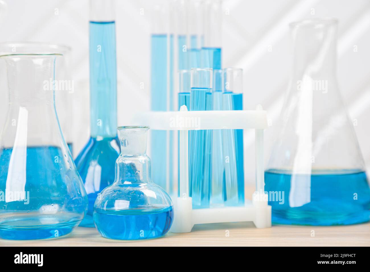 Laboratory glassware with blue liquid in a test tube. scientific ...