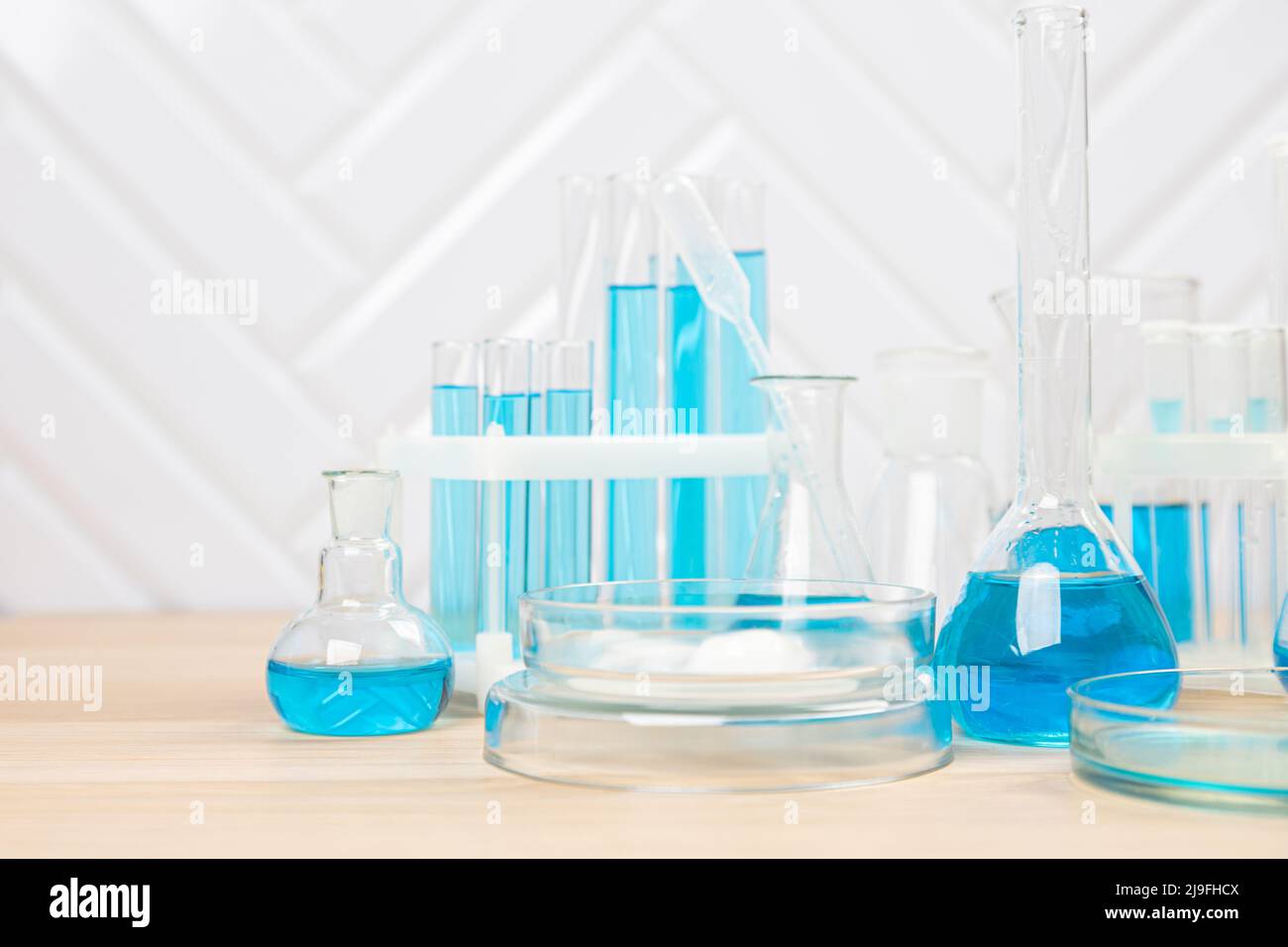 Laboratory glassware with blue liquid in a test tube. scientific ...
