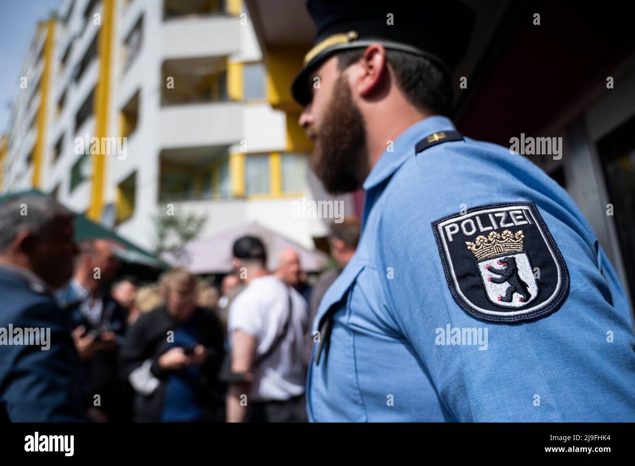 Berlin, Germany. 23rd May, 2022. A police officer stands in front of the planned new police