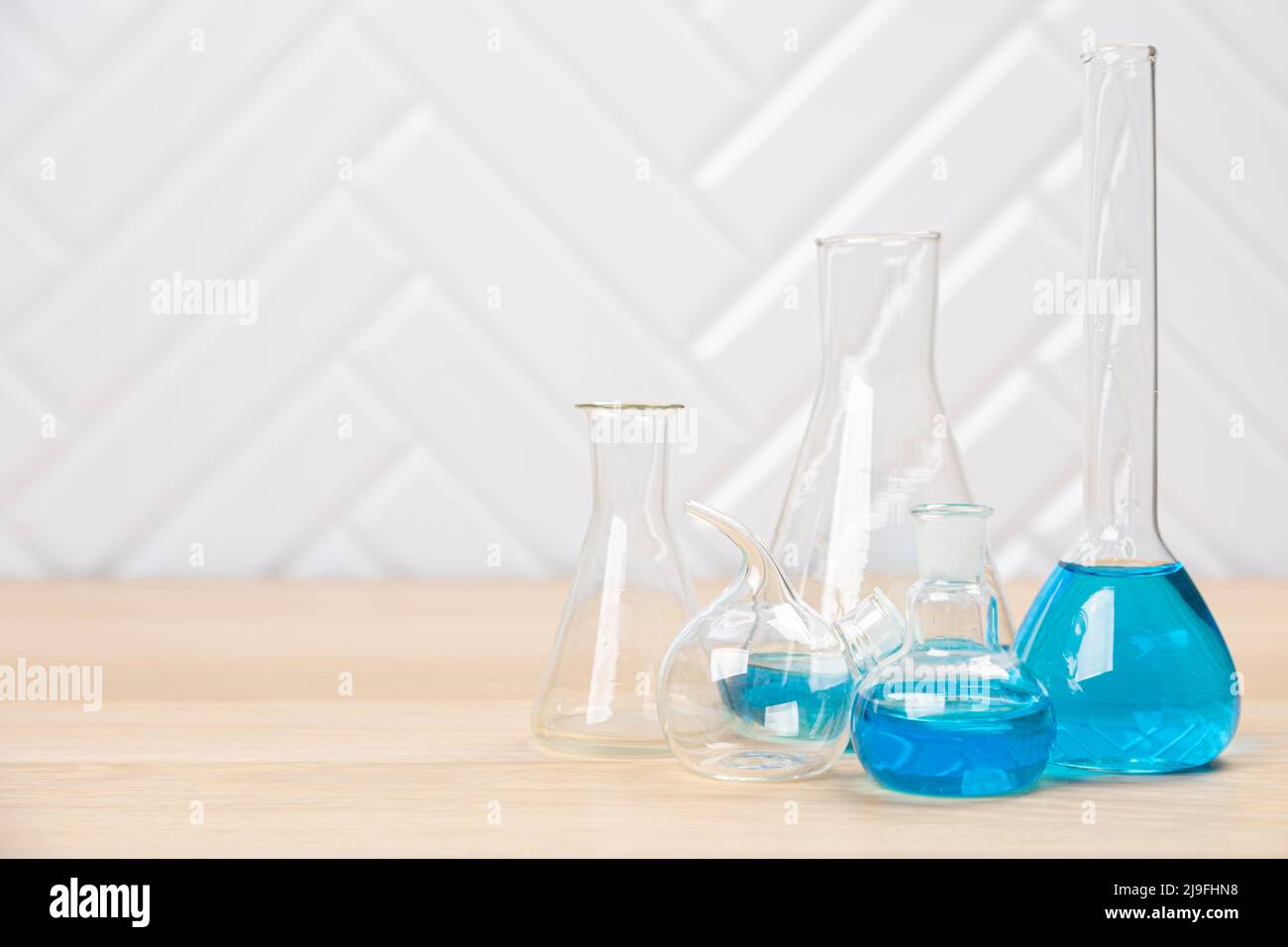 Laboratory glassware with test tubes. flasks, dropper, petri dishes ...