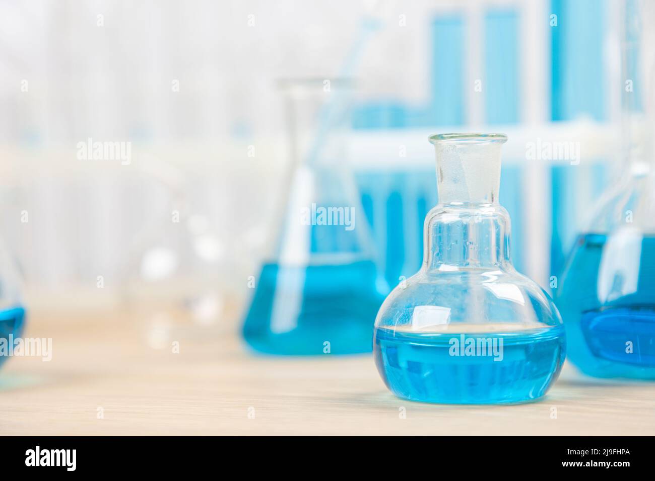 Laboratory glassware with blue liquid in a test tube. scientific ...