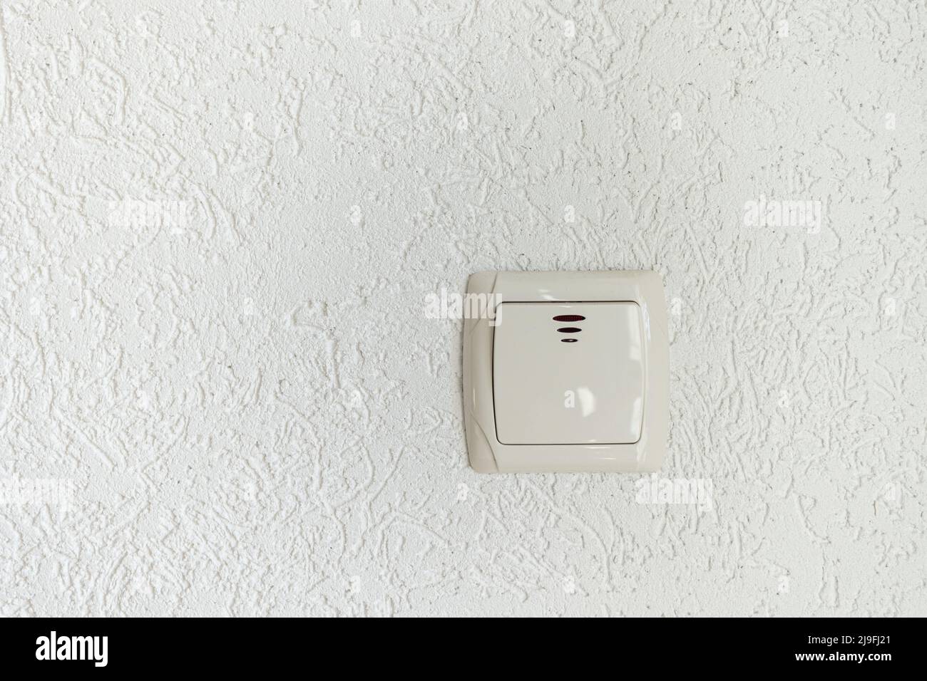 white light switch on empty wall with place for text modern look Stock Photo