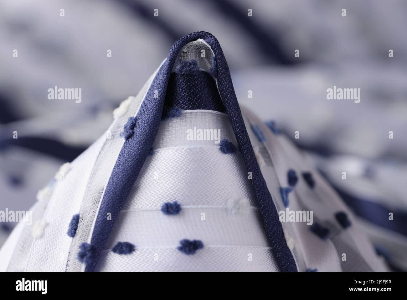 White fabric with blue cone inserts closeup Stock Photo