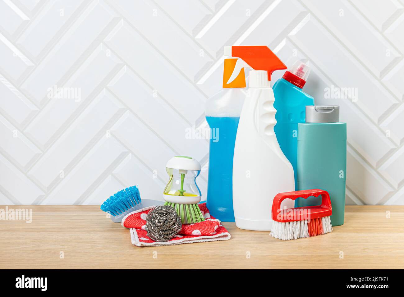 Cleaning concept. Set of cleaning detergents in colored plastic bottles