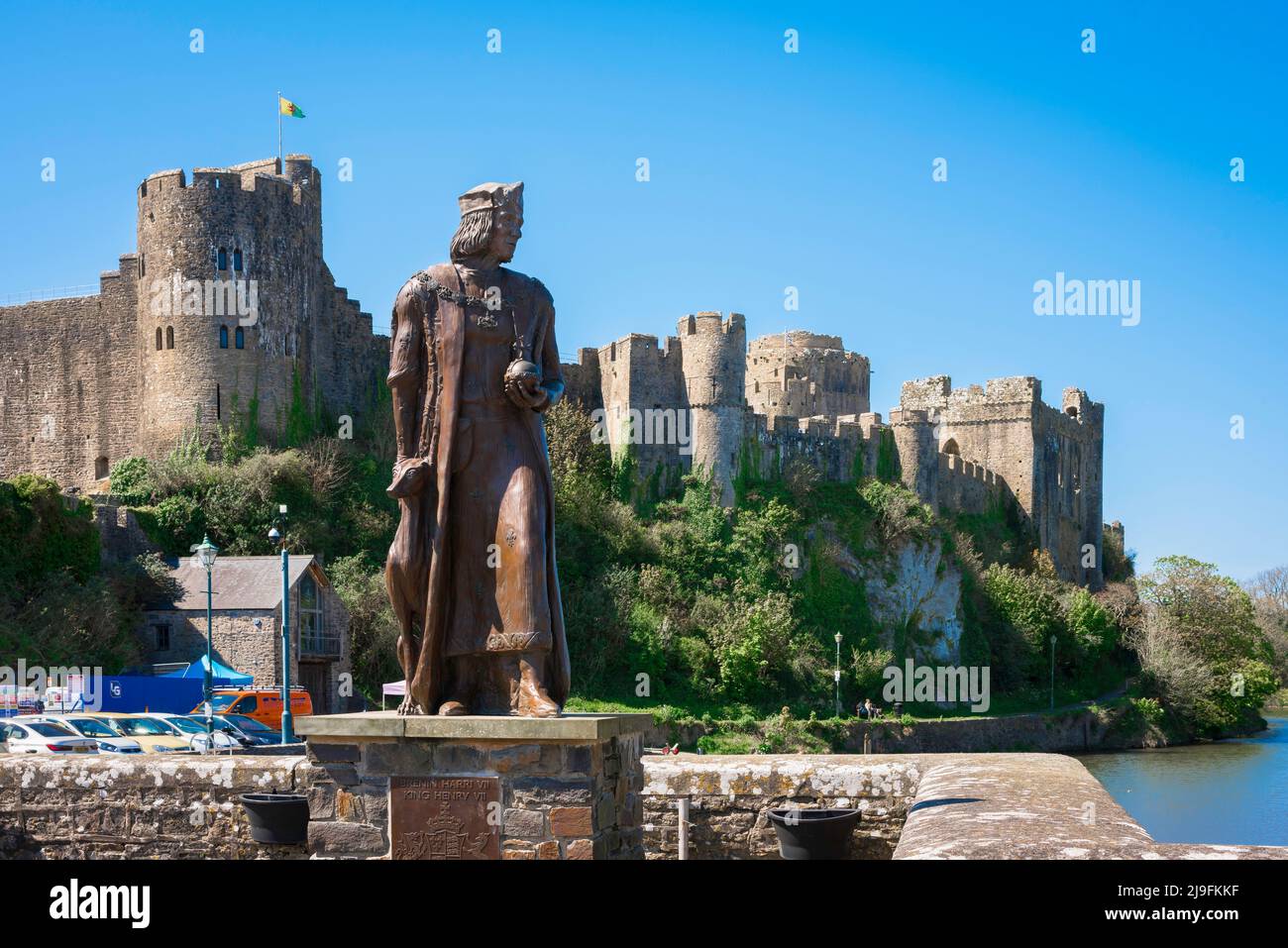 Pembroke Wales, view of Pembroke Castle with the  statue of King Henry VII sited on Mill Bridge in Northgate Street, Pembroke, Pembrokeshire, Wales UK Stock Photo