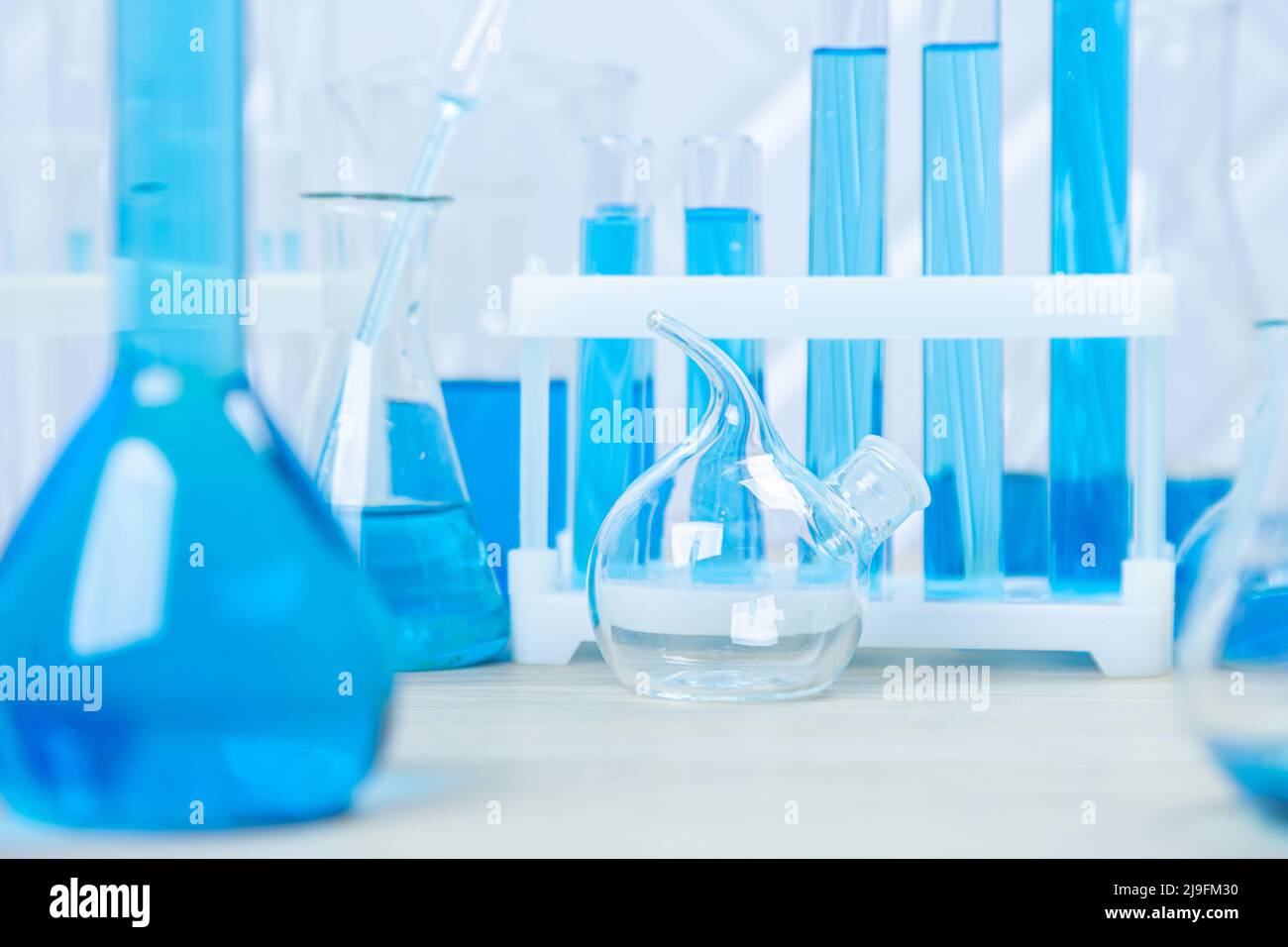 Laboratory glassware with blue liquid in a test tube. scientific ...