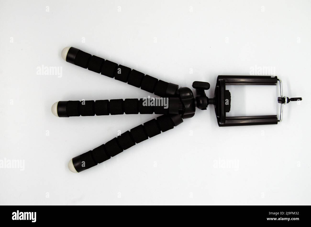 Isolated single mini smartphone tripod on white background Stock Photo