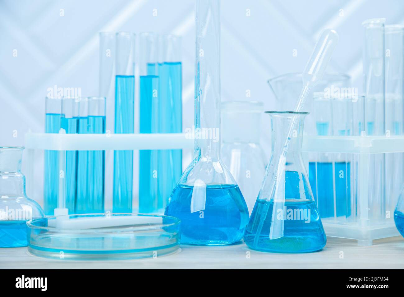 Laboratory glassware with blue liquid in a test tube. scientific ...