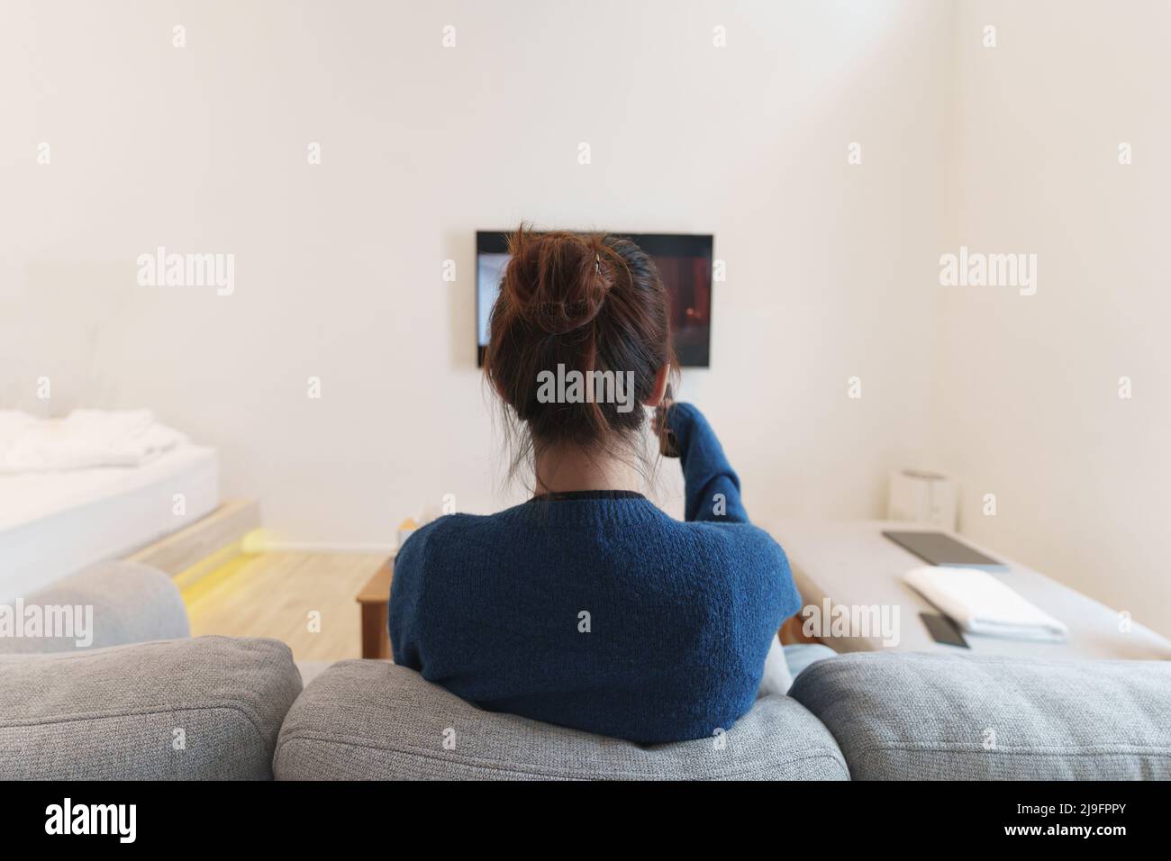 Excited, happy modern woman watch world cup football match, championship on the couch at home. Sport, TV, having fun. Stock Photo