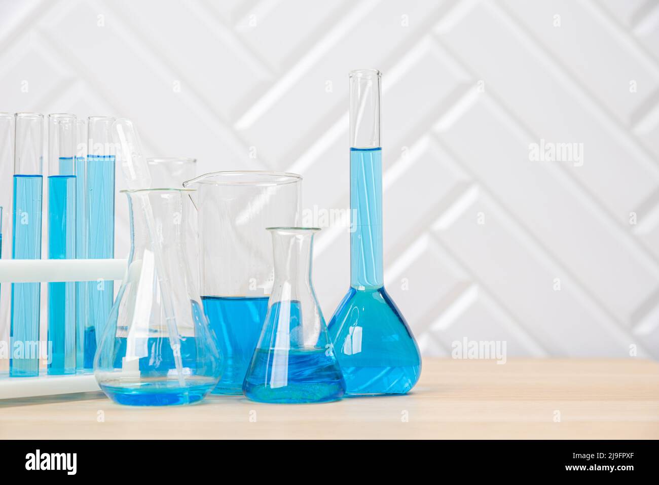 Laboratory glassware with blue liquid in a test tube. scientific ...
