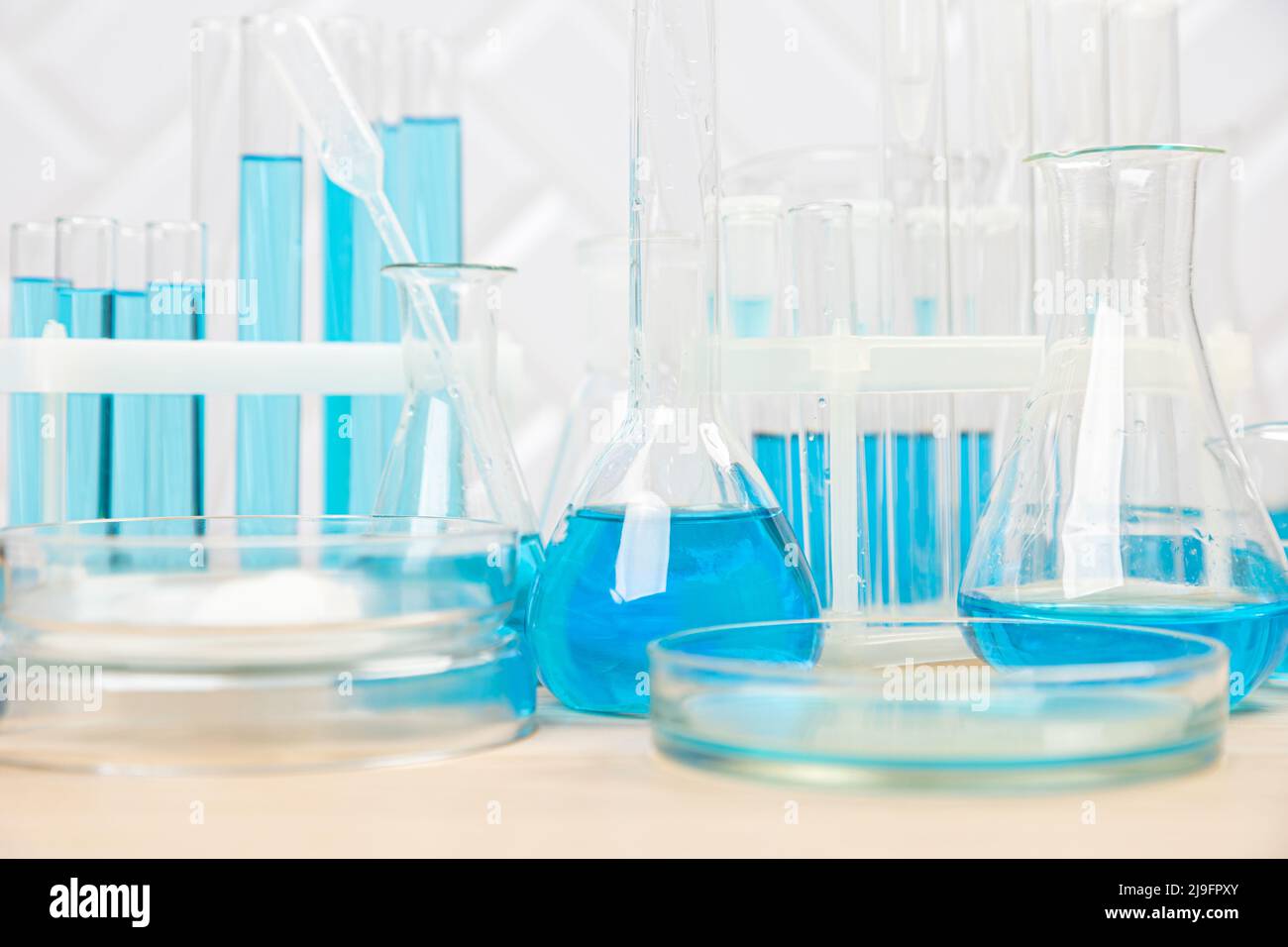 Laboratory glassware with blue liquid in a test tube. scientific ...