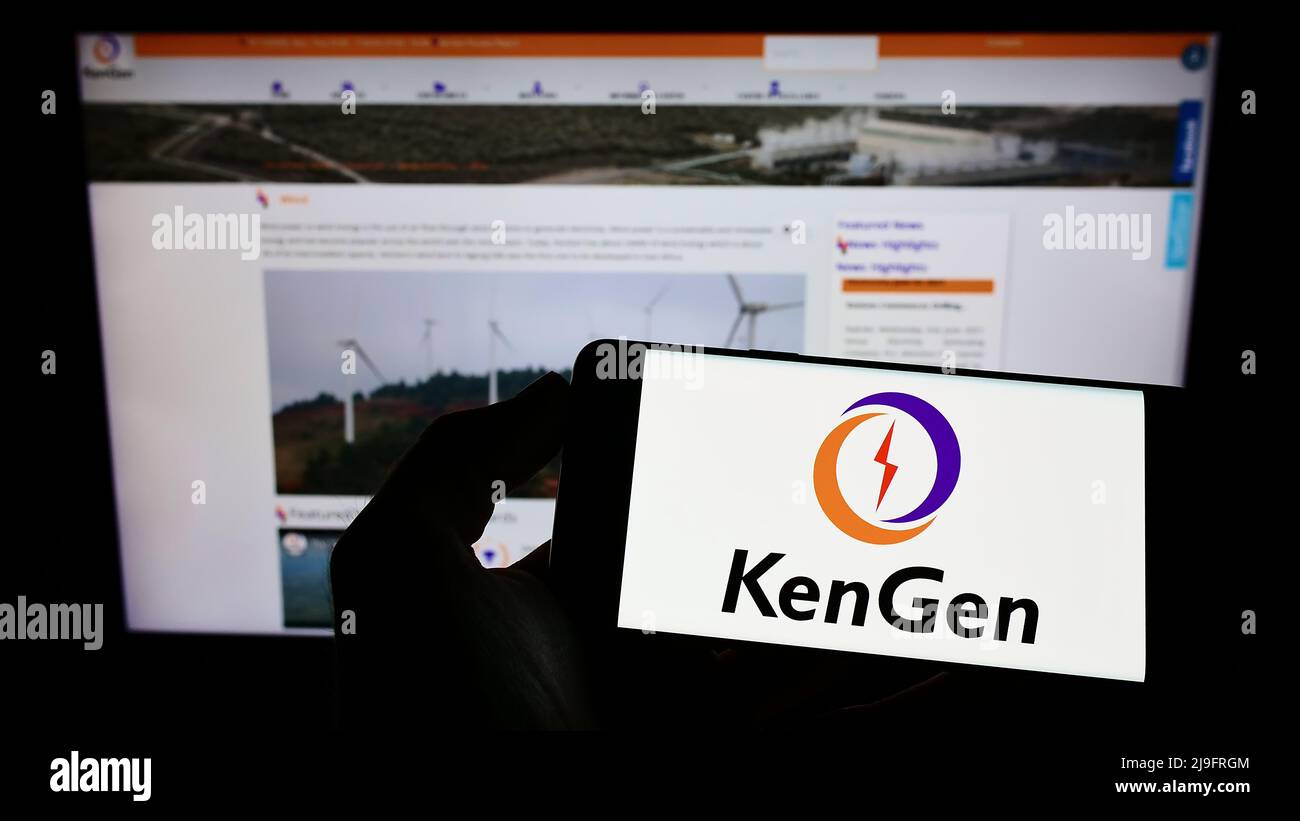 Person holding mobile phone with logo of Kenya Electricity Generating