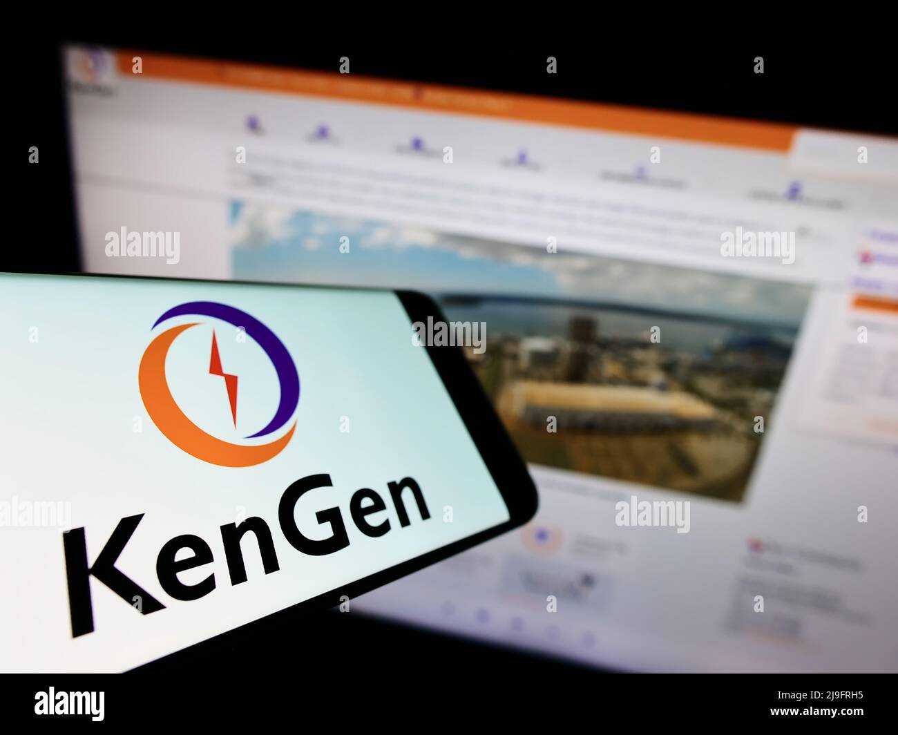 Smartphone with logo of Kenya Electricity Generating Company (KenGen) on screen in front of website. Focus on phone display. Stock Photo