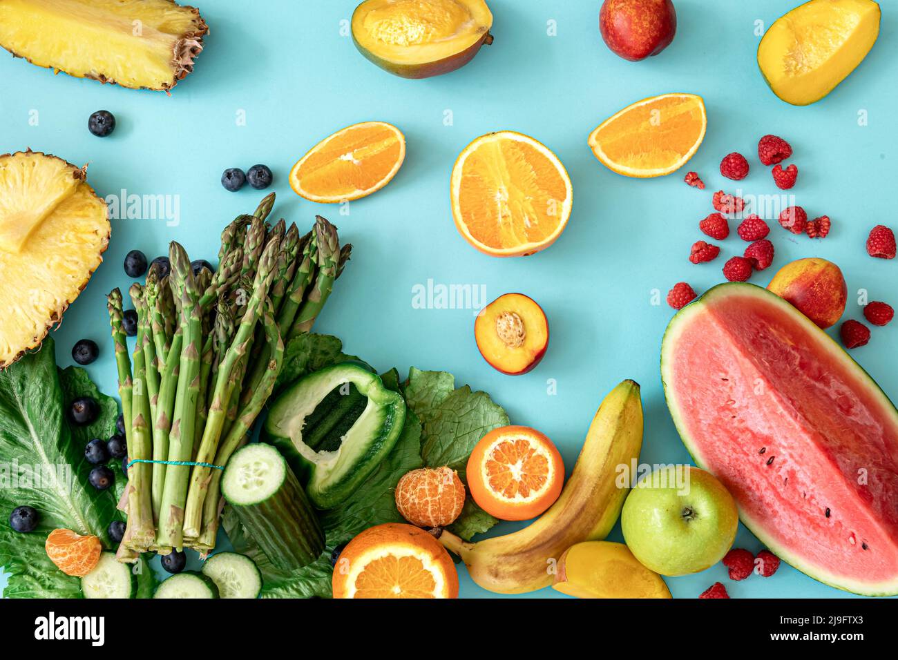 Fruits, berries and vegetables on a blue background Stock Photo - Alamy