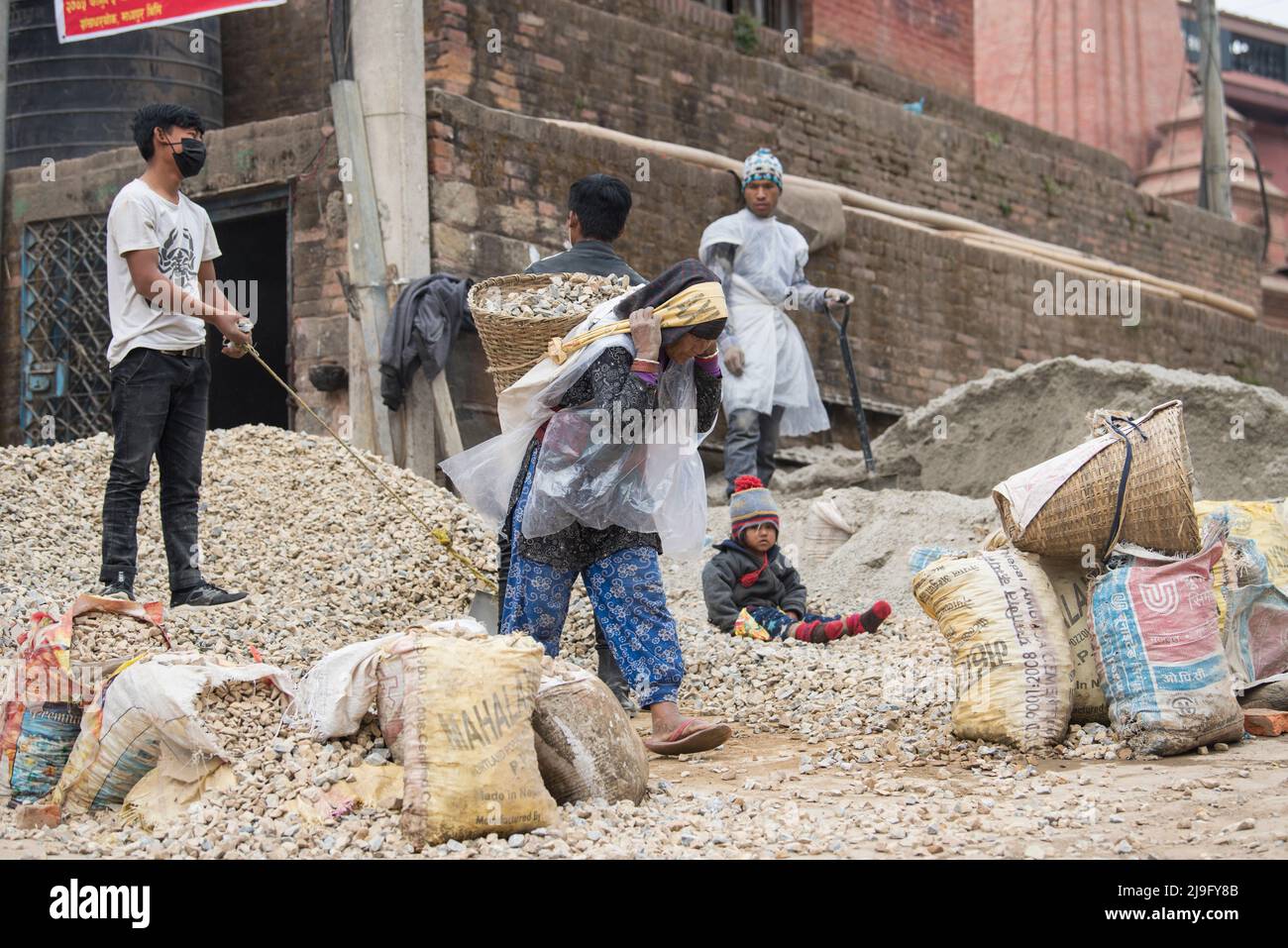 Kathmandu, Nepal- April 20,2022 : Local people of all ages and genders are working to rebuild the ruined old city in a major earthquake in Kathmandu. Stock Photo
