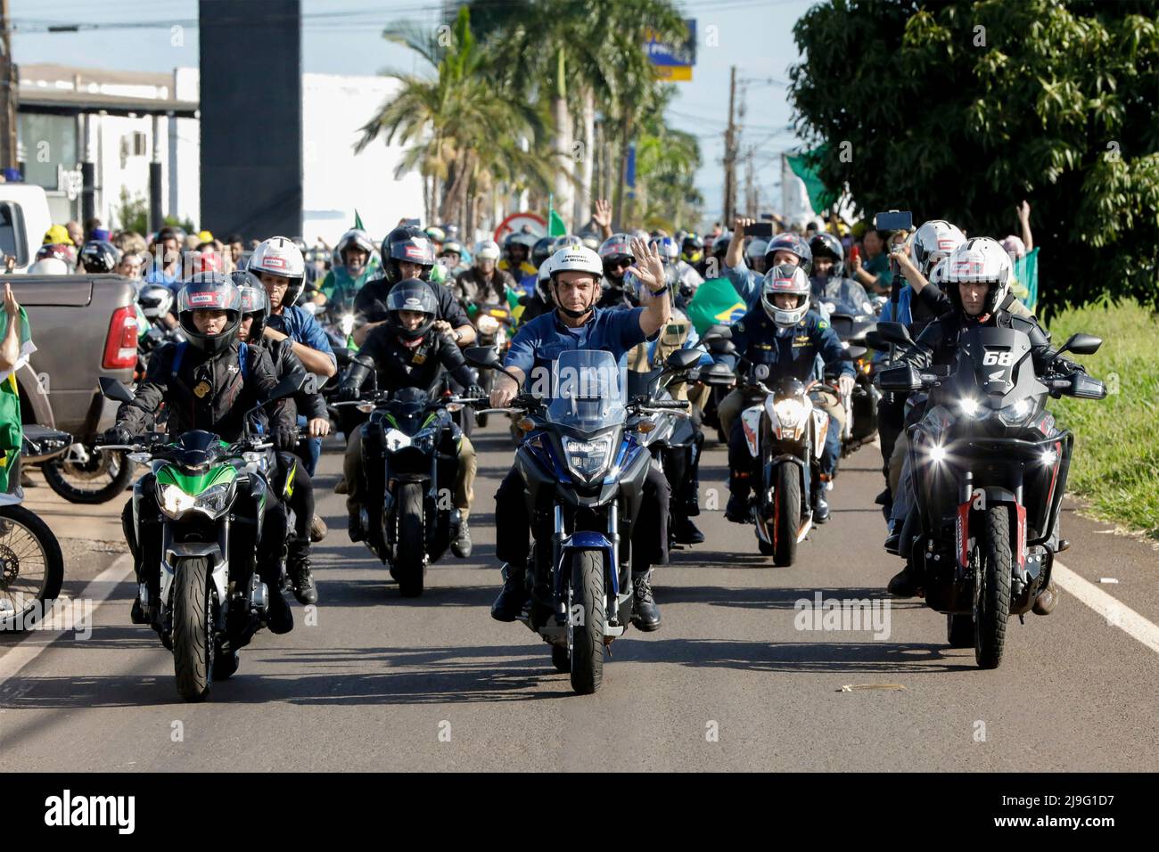 Maringa, Brazil. 11 May, 2022. Brazilian President Jair Bolsonaro, center, leads a motorcycle rally as he rides 10kms from the airport to the 48th Expoinga Agricultural fair at the Francisco Feio Ribeiro Expo Center, May 11, 2022 in Maringa, Brazil. Credit: Alan Santos/President Brazil/Alamy Live News Stock Photo
