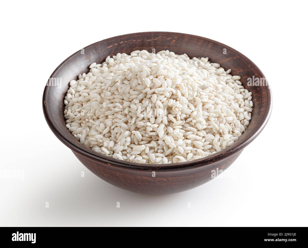 Uncooked arborio rice in ceramic bowl isolated on white background with