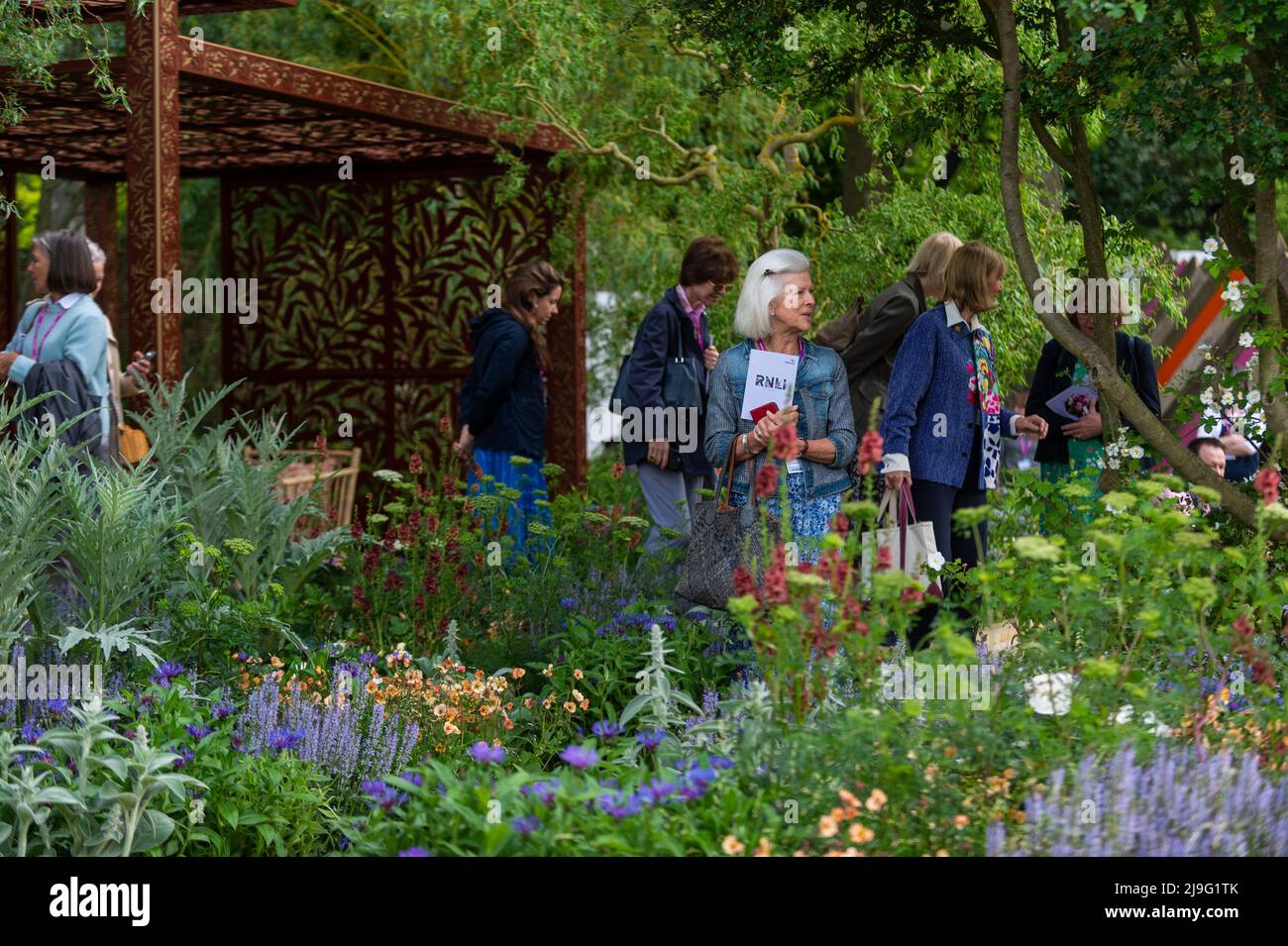 London, UK.  23 May 2022. Visitors at the Morris & Co. garden at the press day of the RHS Chelsea Flower Show in the grounds of the Royal Hospital Chelsea.  The show runs to 28 May 2022.  Credit: Stephen Chung / Alamy Live News Stock Photo