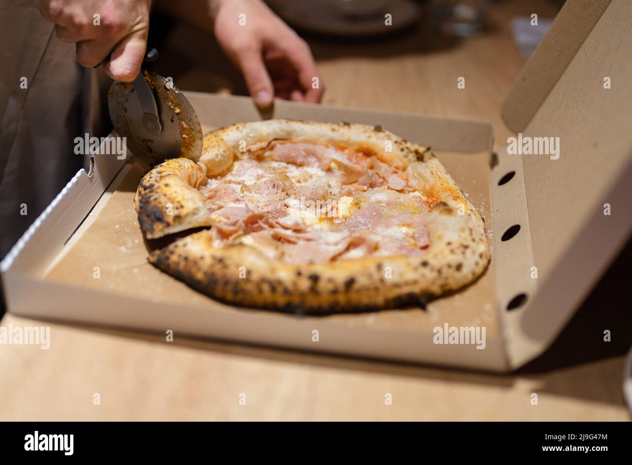 Jjust now cooked pizza from oven inside a pizza box ready for delivery