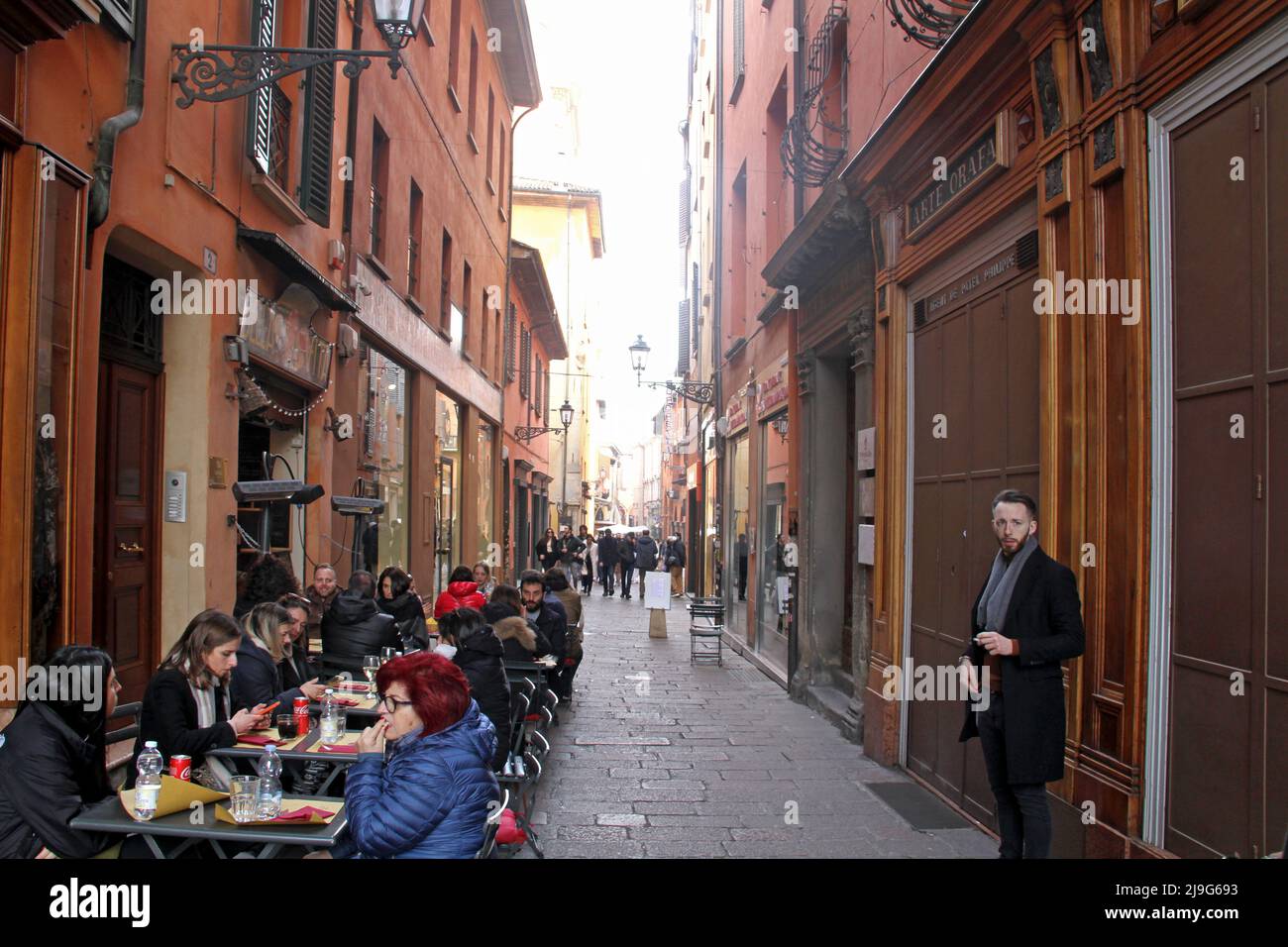 Bologna, Italy. Outdoor seating area of a local restaurant on one of the narrow streets in the