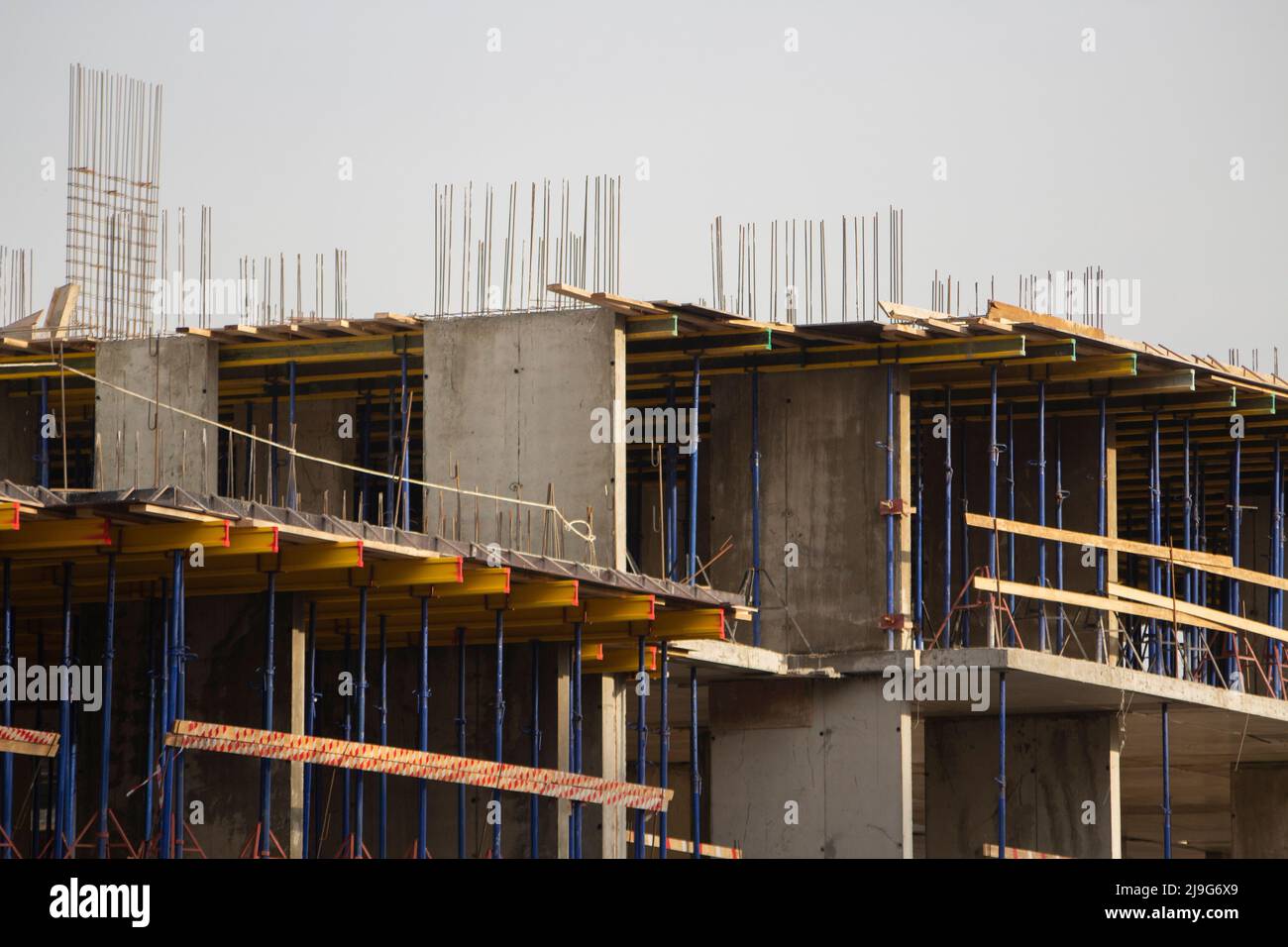 Construction of residential building. Wall of unfinished building. Construction details. Preparation of walls for cladding. Concrete and metal are mai Stock Photo