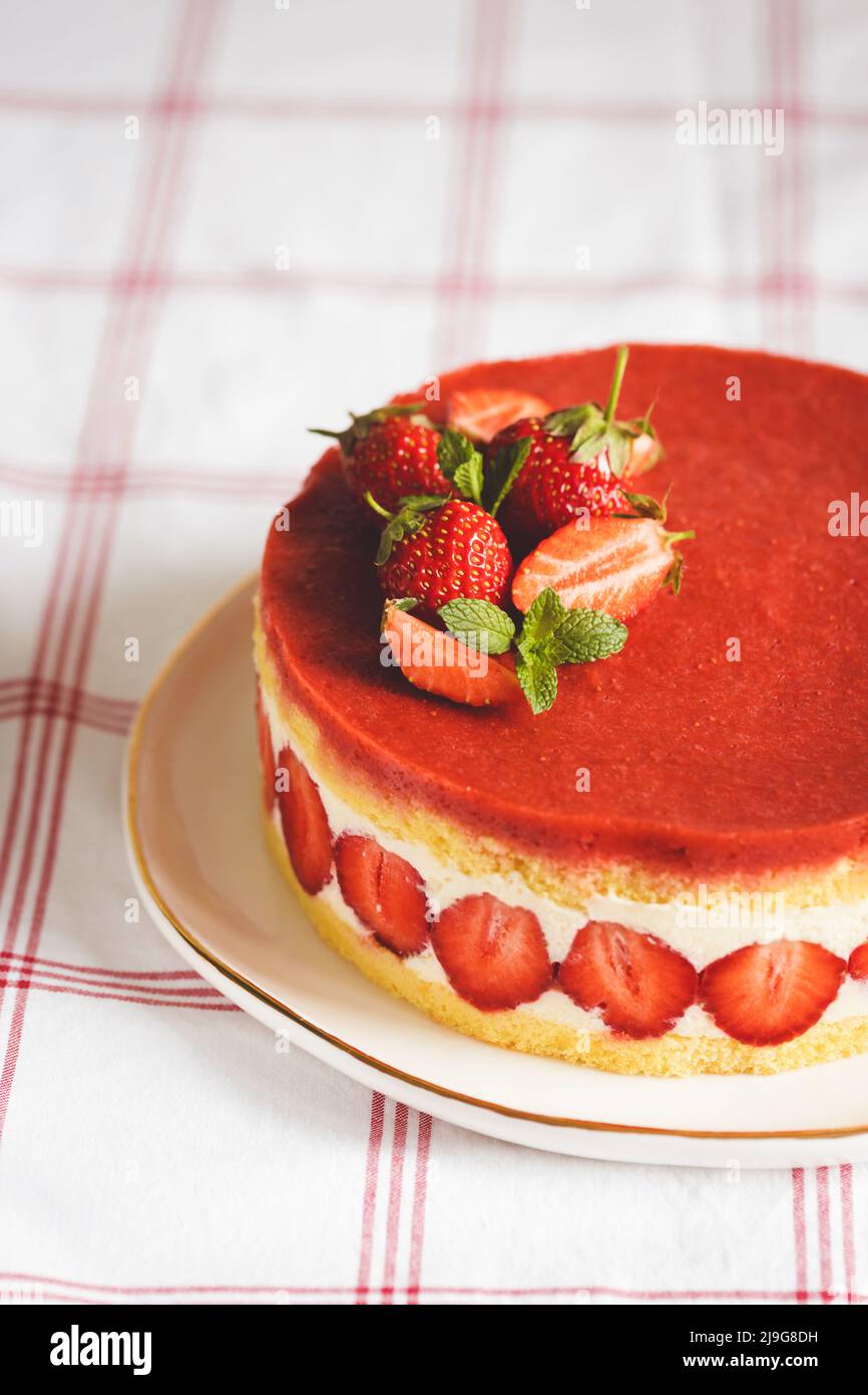 French strawberry cake Fraisier on white plate. Stock Photo
