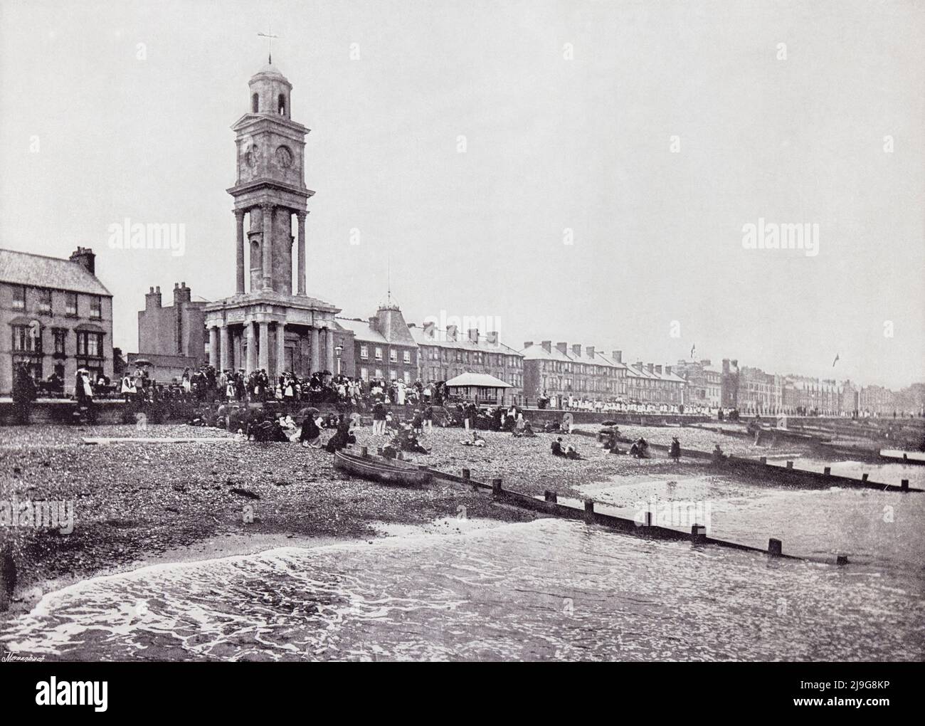 Herne Bay, Kent, England, showing the promenade and the clock tower in the 19th century.  From Around The Coast,  An Album of Pictures from Photographs of the Chief Seaside Places of Interest in Great Britain and Ireland published London, 1895, by George Newnes Limited. Stock Photo