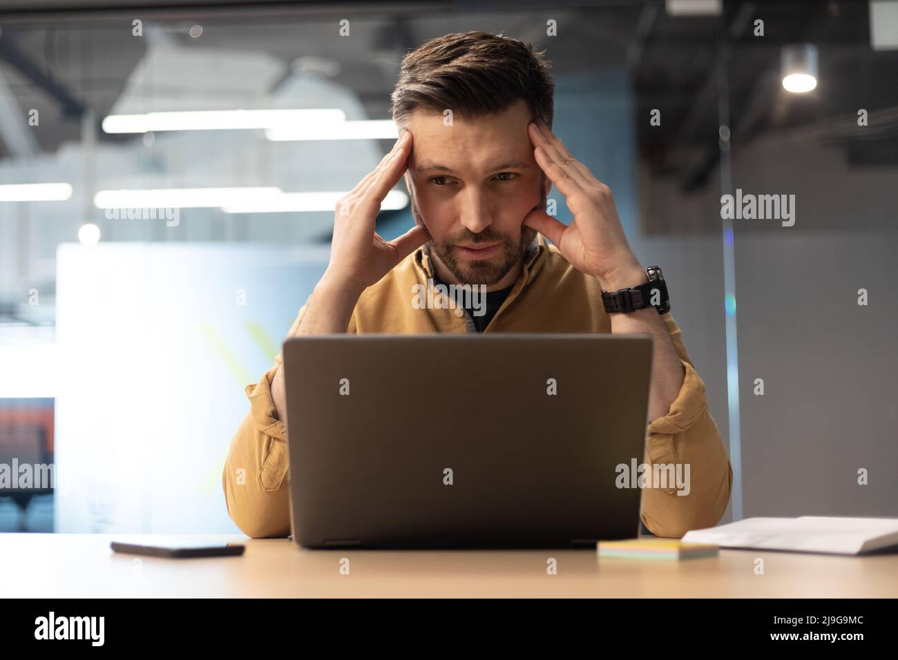 Businessman Using Laptop Suffering From Headache Having Problems In Office Stock Photo