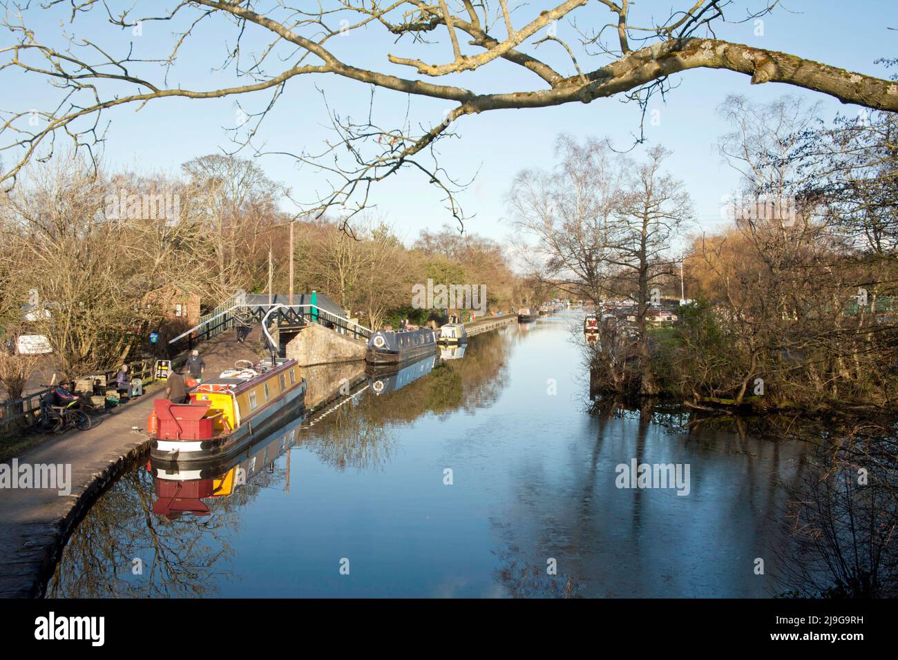Narrow boats moored along the Macclesfield Canal on a bright winter day at Higher Poynton Cheshire England Stock Photo
