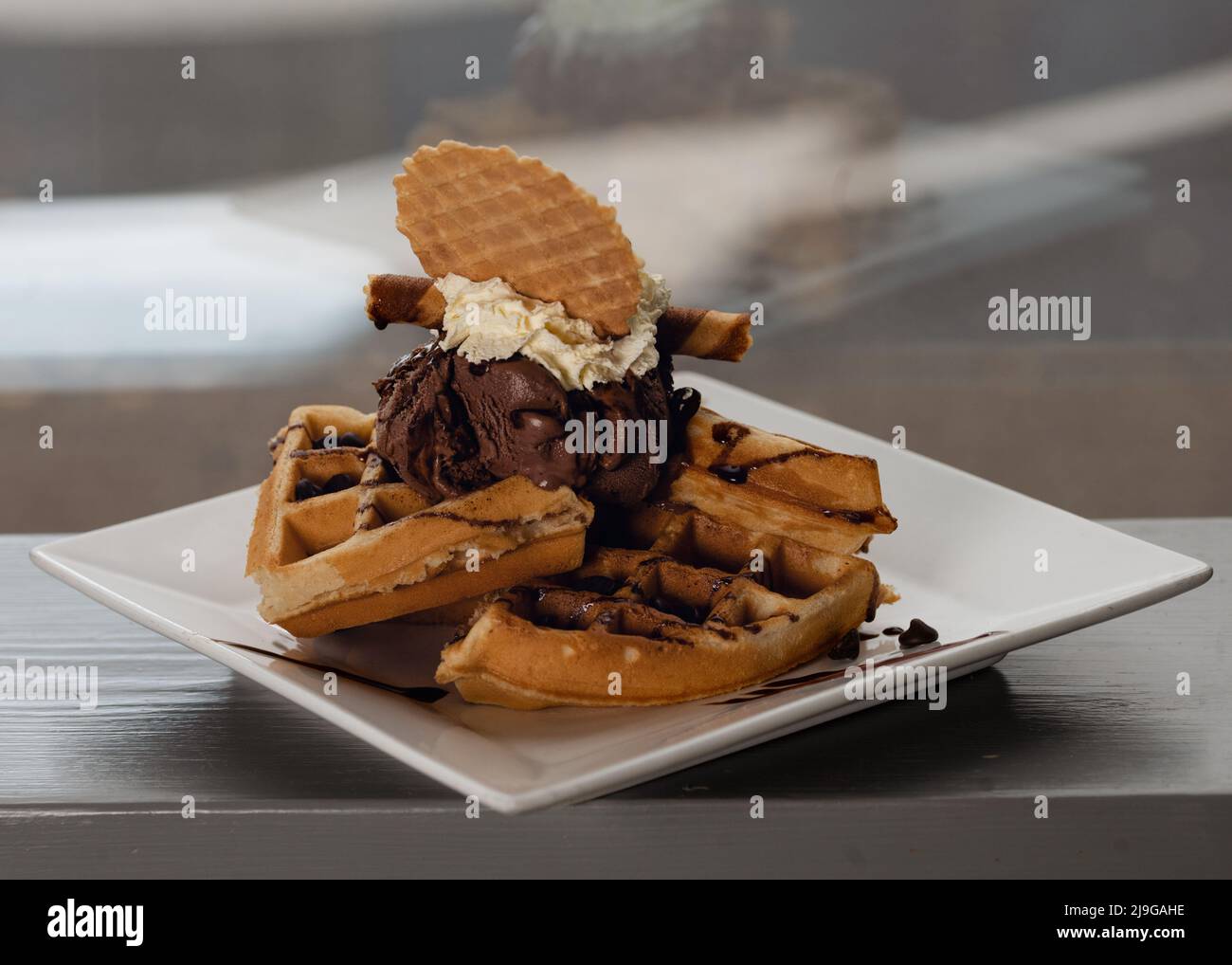 Belgian waffles in chocolate hi-res stock photography and images - Alamy