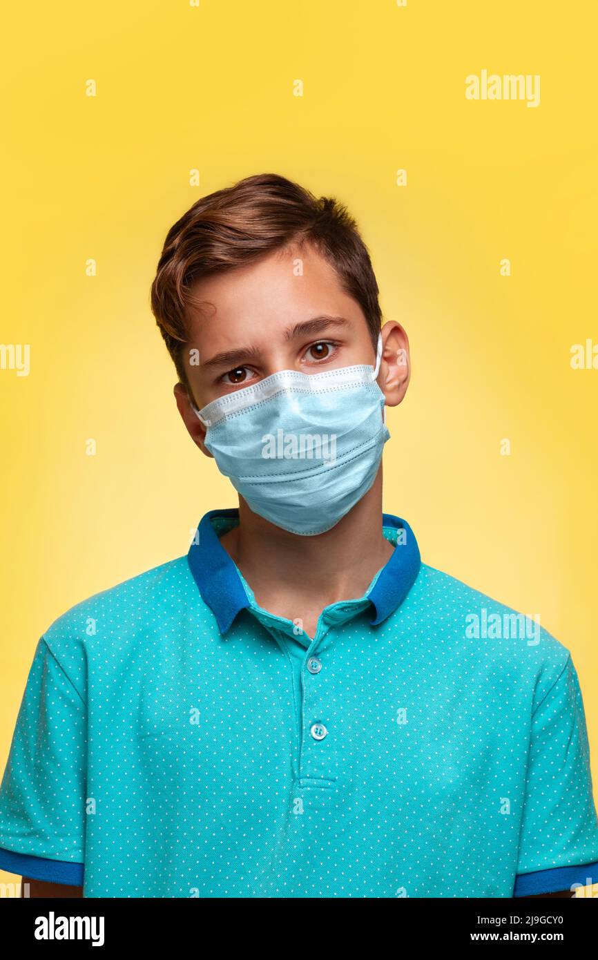The concept of protection against viruses and diseases. A teenage boy in a blue tshirt and mask