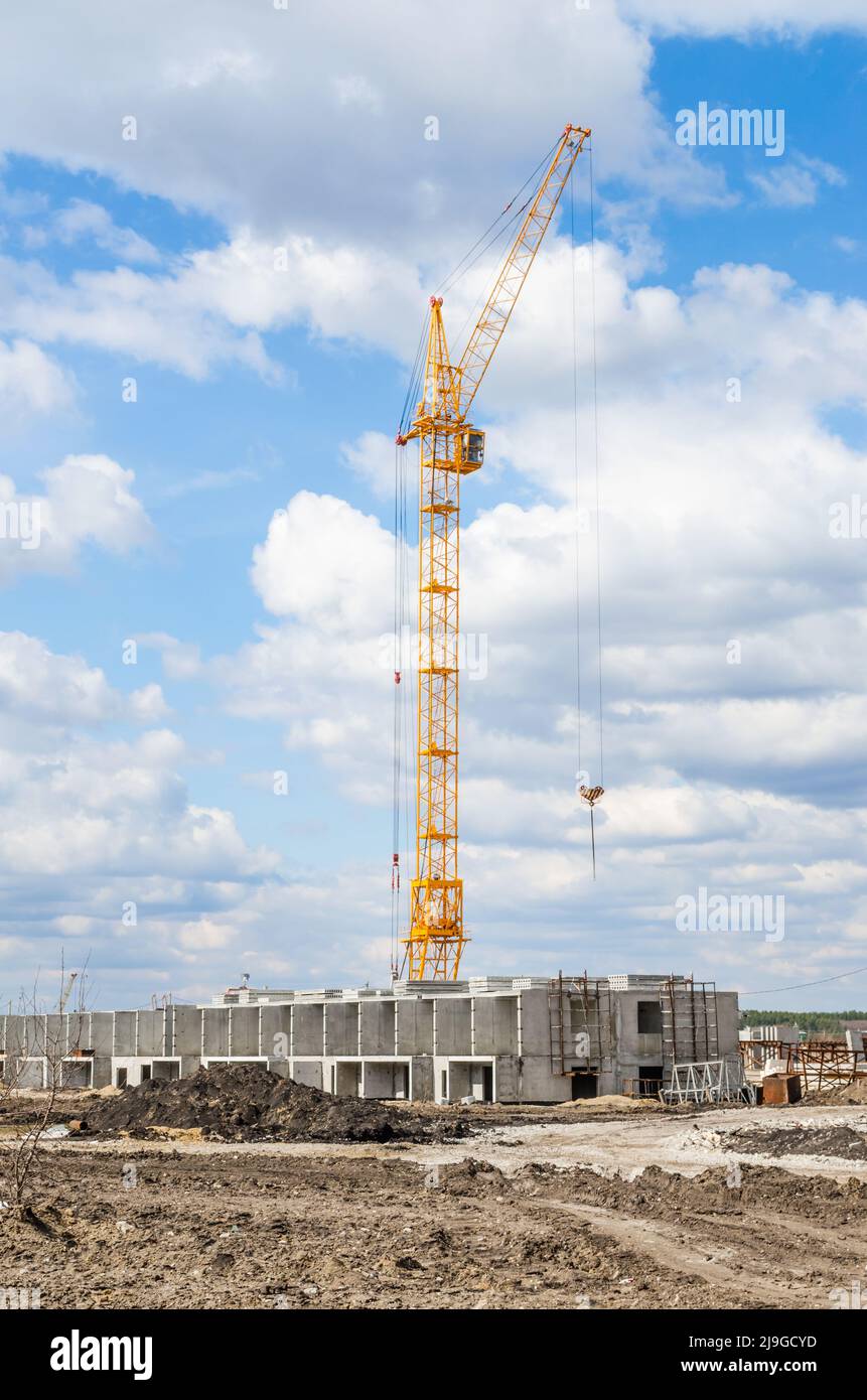 Silhouette Lift crane on construction site with blue sky and white cloud Stock Photo