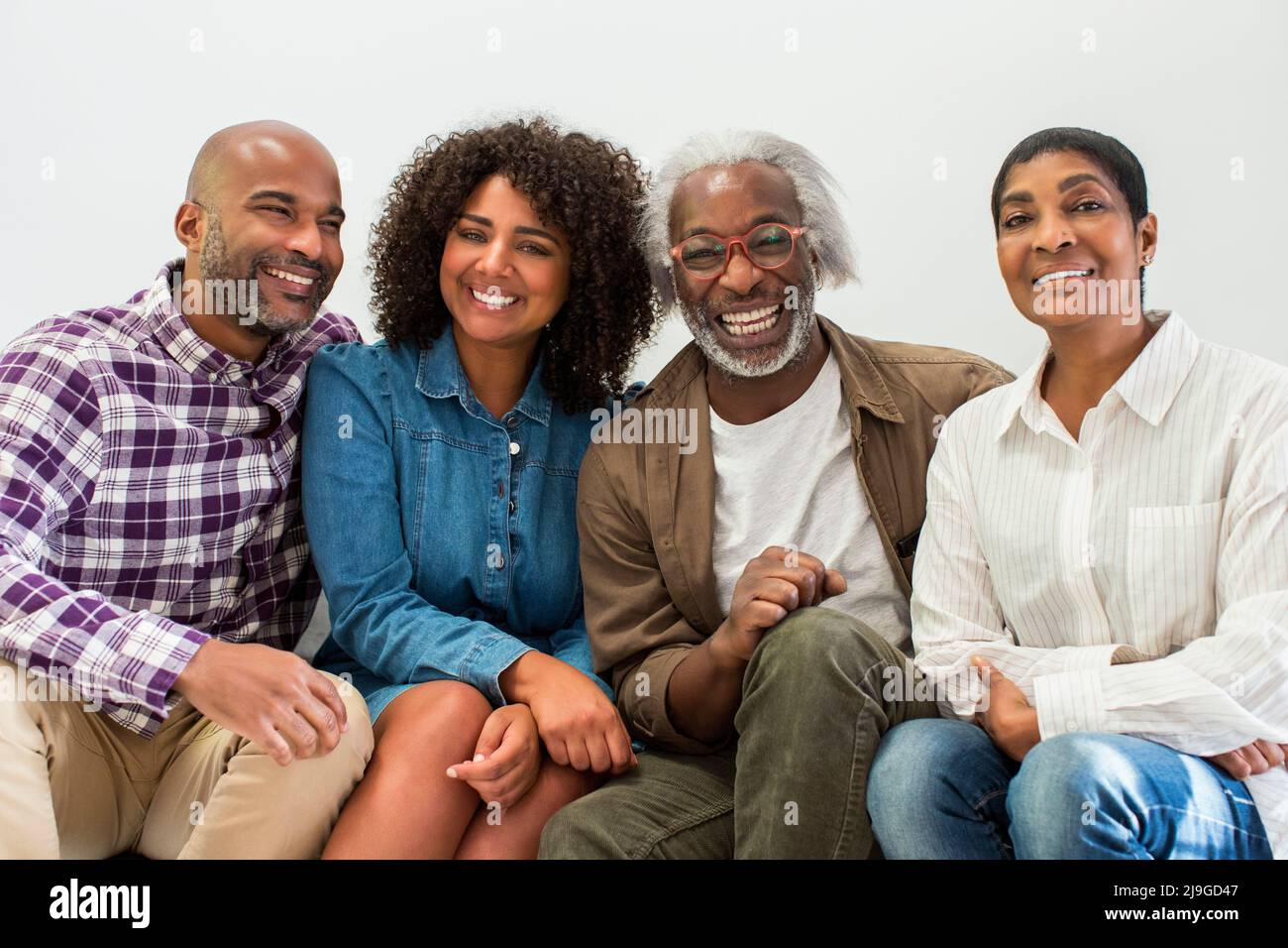 Happy multi-generation family sitting in living room Stock Photo
