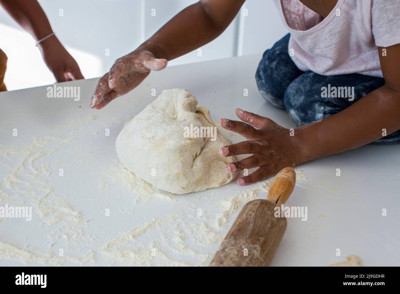 Girl kneading dough in kitchen Stock Photo Alamy