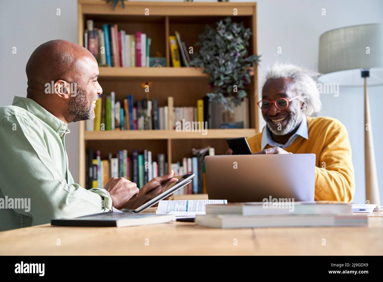 Smiling father and son using technologies Stock Photo