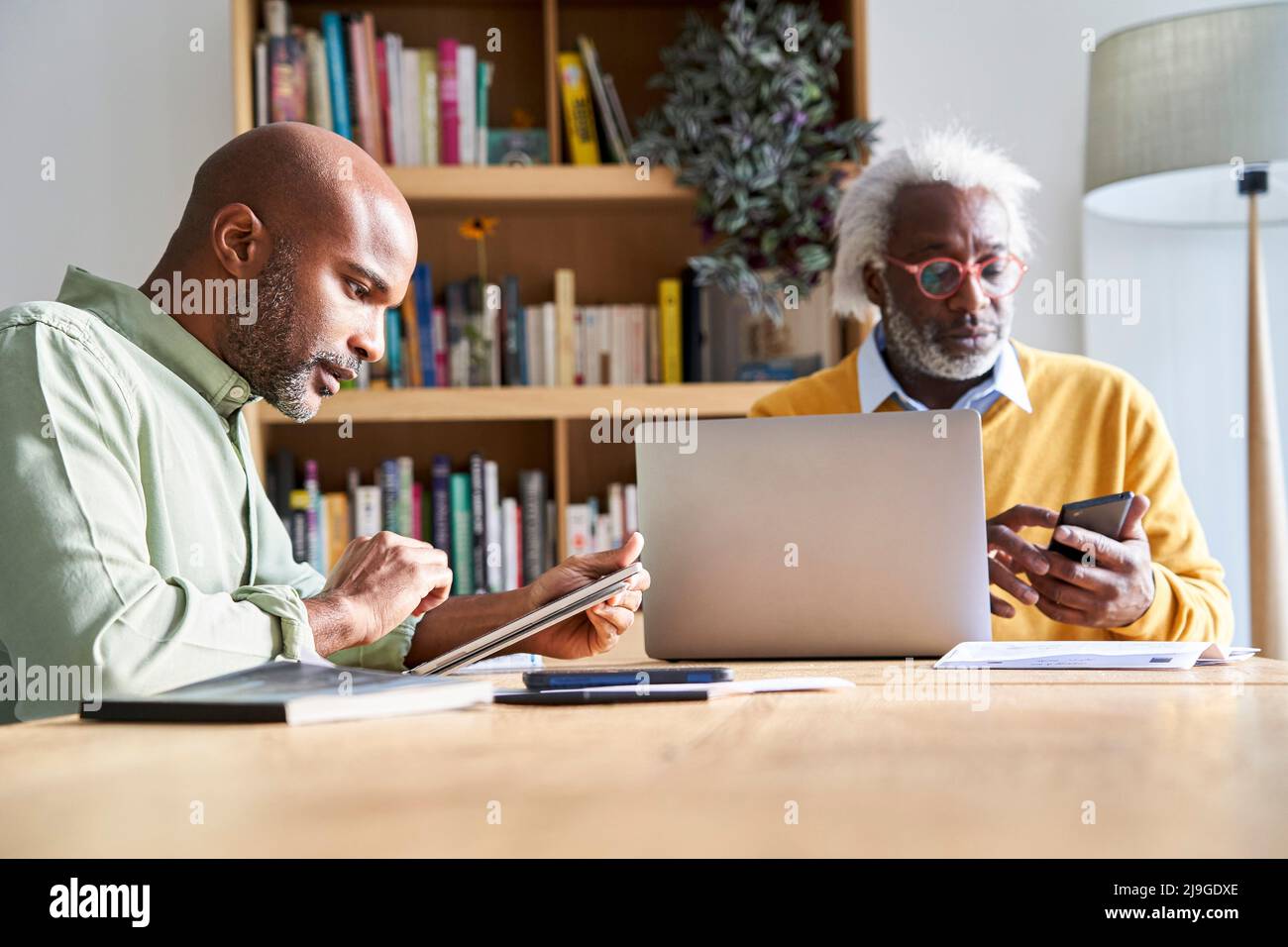 Father and son using technologies Stock Photo