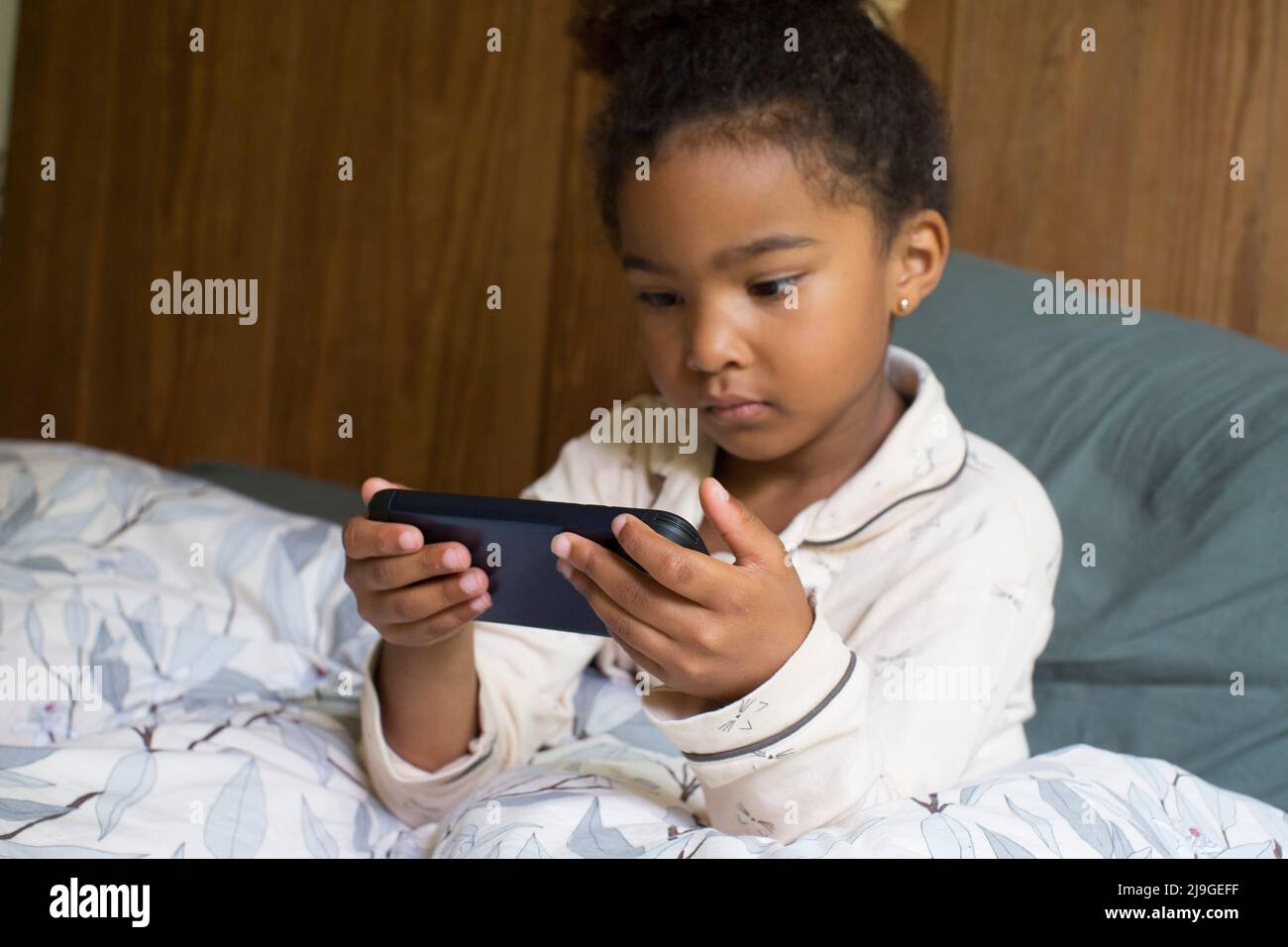 Girl looking at smart phone Stock Photo