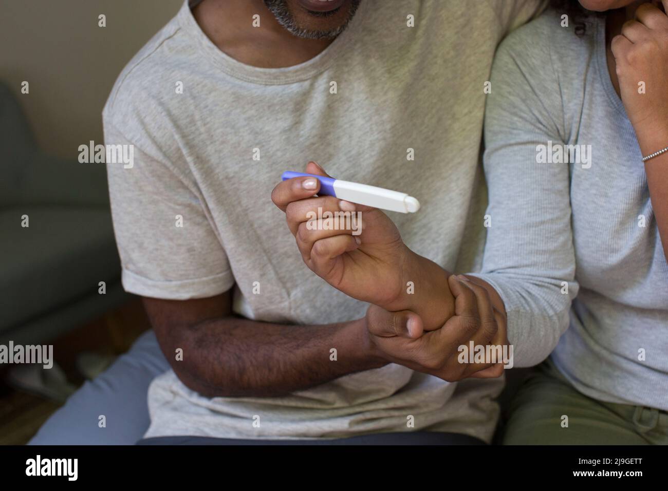 Close up of a woman's hand holding a pregnancy test kit Stock Photo